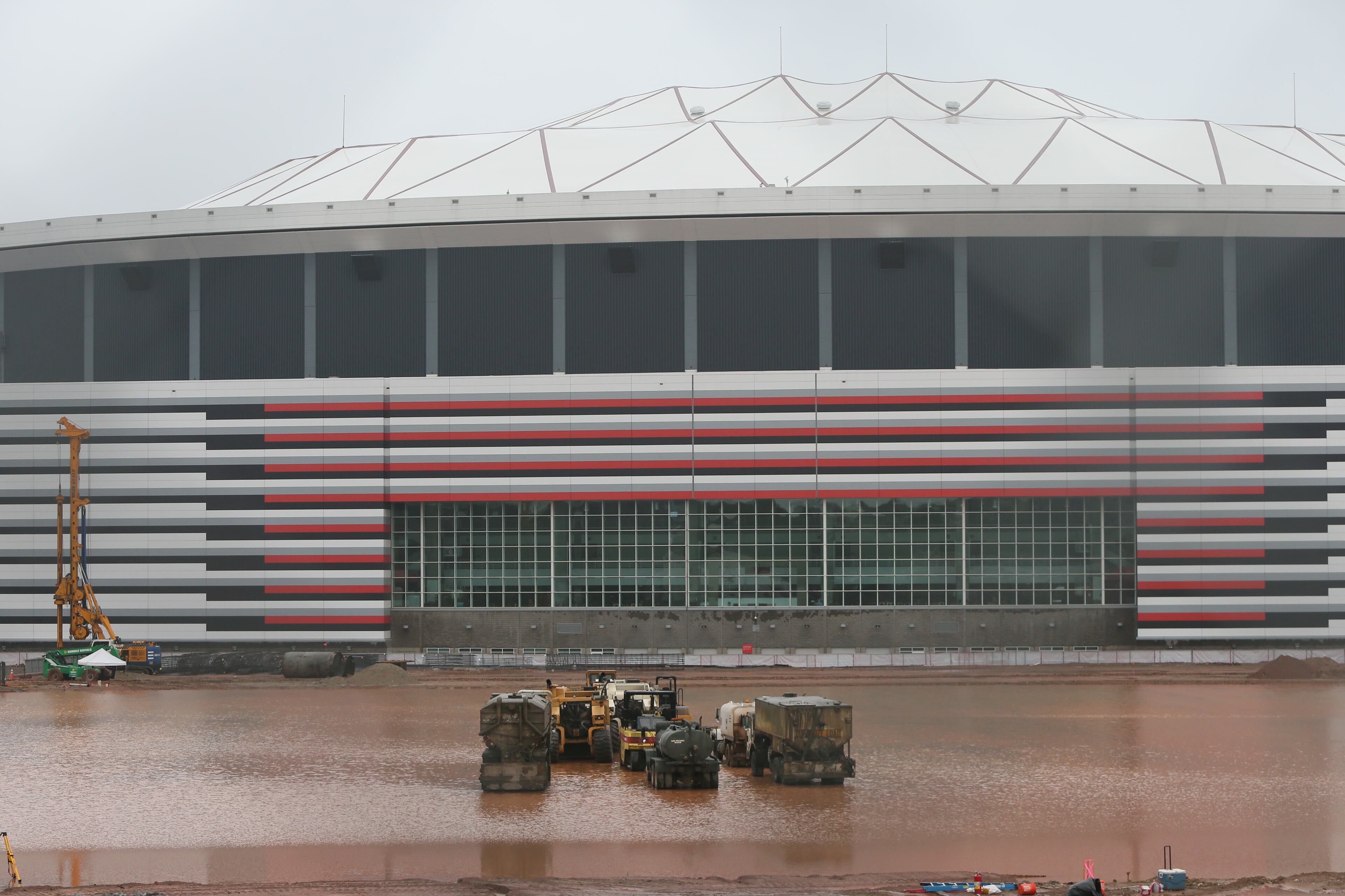 The rain that persisted through much of the weekend continued into Monday, and forecasters are predicting a 30 to 40 percent chance of rain all week. The site of the new Falcon's stadium is just one of the locations that has been affected by the weather. BOB ANDRES/BANDRES@AJC.COM