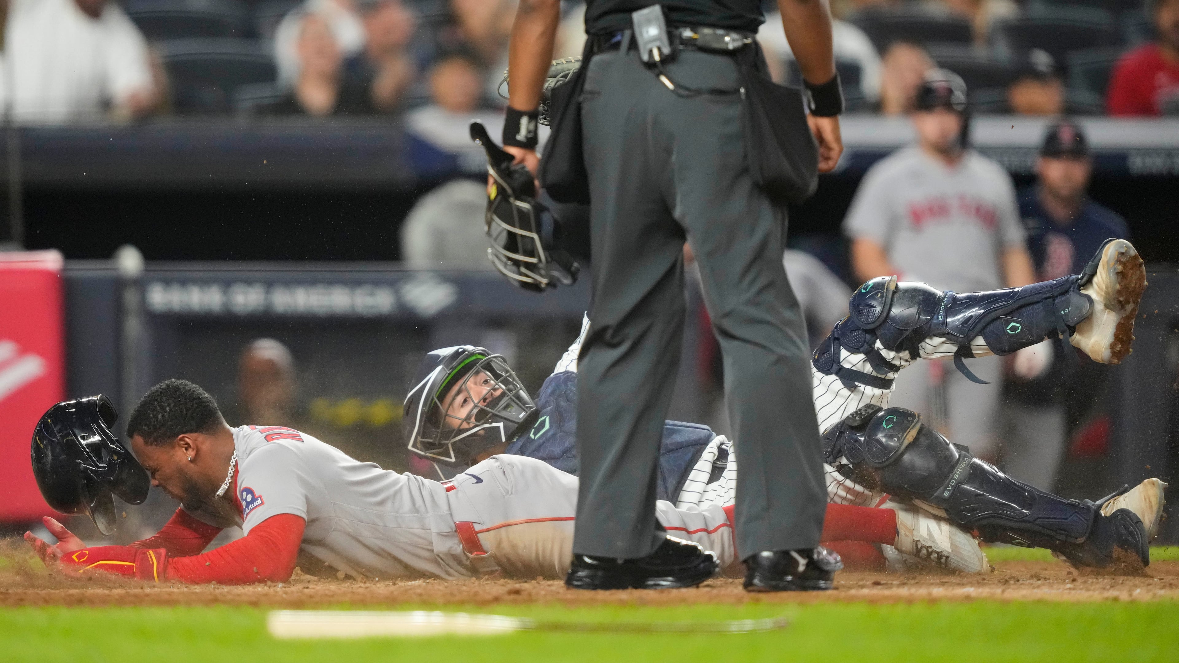Boston Red Sox' Ceddanne Rafaela is tagged out by New York Yankees catcher Austin Wells at home plate on a double play during the seventh inning of a baseball game, Friday, Aug. 28, 2026, in New York. (AP Photo/Yuki Iwamura)