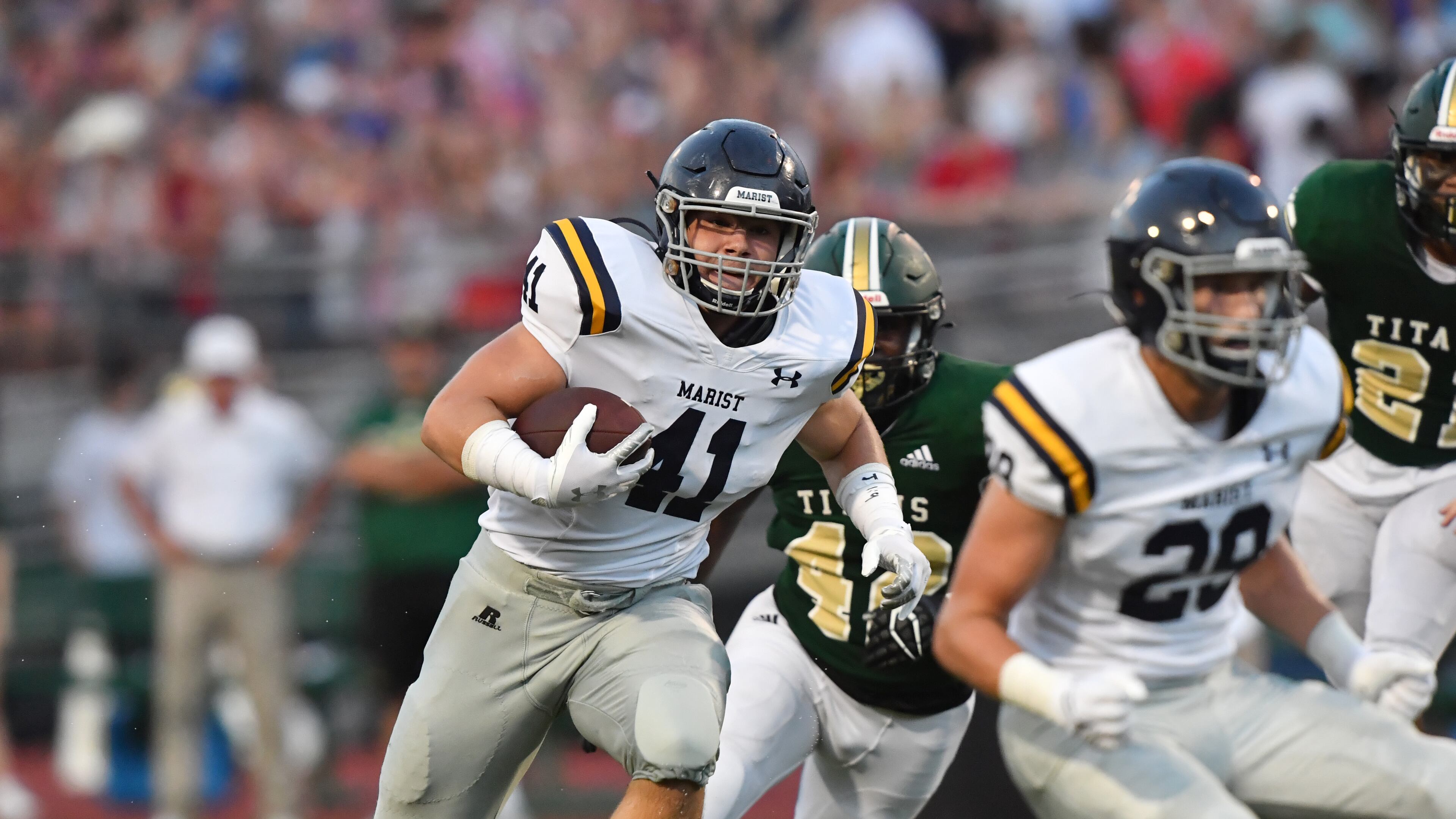 August 27, 2021 Roswell - Marist's Jackson Hughes runs for a first down in the first half at Blessed Trinity Catholic High School in Roswell on Friday, August 27, 2021. (Hyosub Shin / Hyosub.Shin@ajc.com)