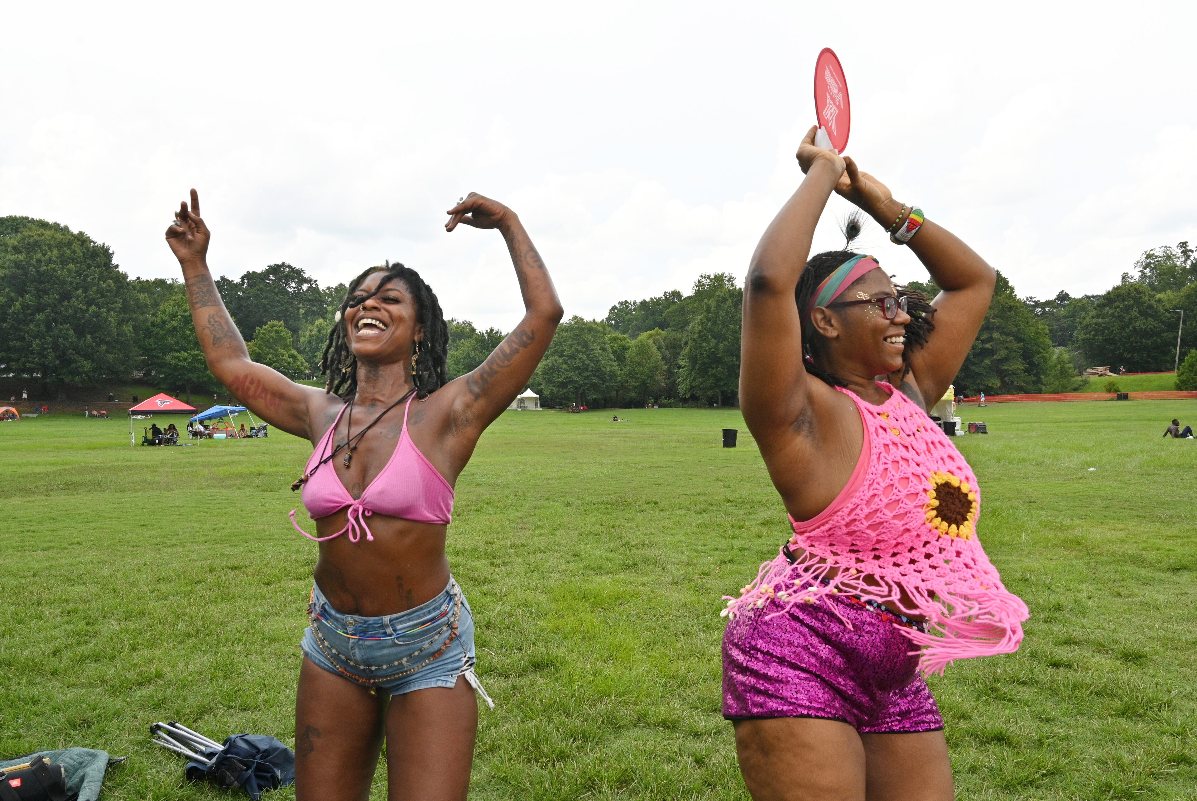 Leilani Battiste (left) and Nefertari Patterson dance during the 10 year anniversary of the BeREGGAE Music and Arts Festival at Piedmont Park, Saturday, August 12, 2023, in Atlanta. The 10th anniversary of the BeREGGAE Music and Arts Festival arrives August 11th -13th. BeREGGAE Festival was established in 2013 and has organically grown into one of the largest 3 DAY Reggae / Caribbean music festivals in the country and hosts thousands of families in free and safe environment. (Hyosub Shin / Hyosub.Shin@ajc.com)