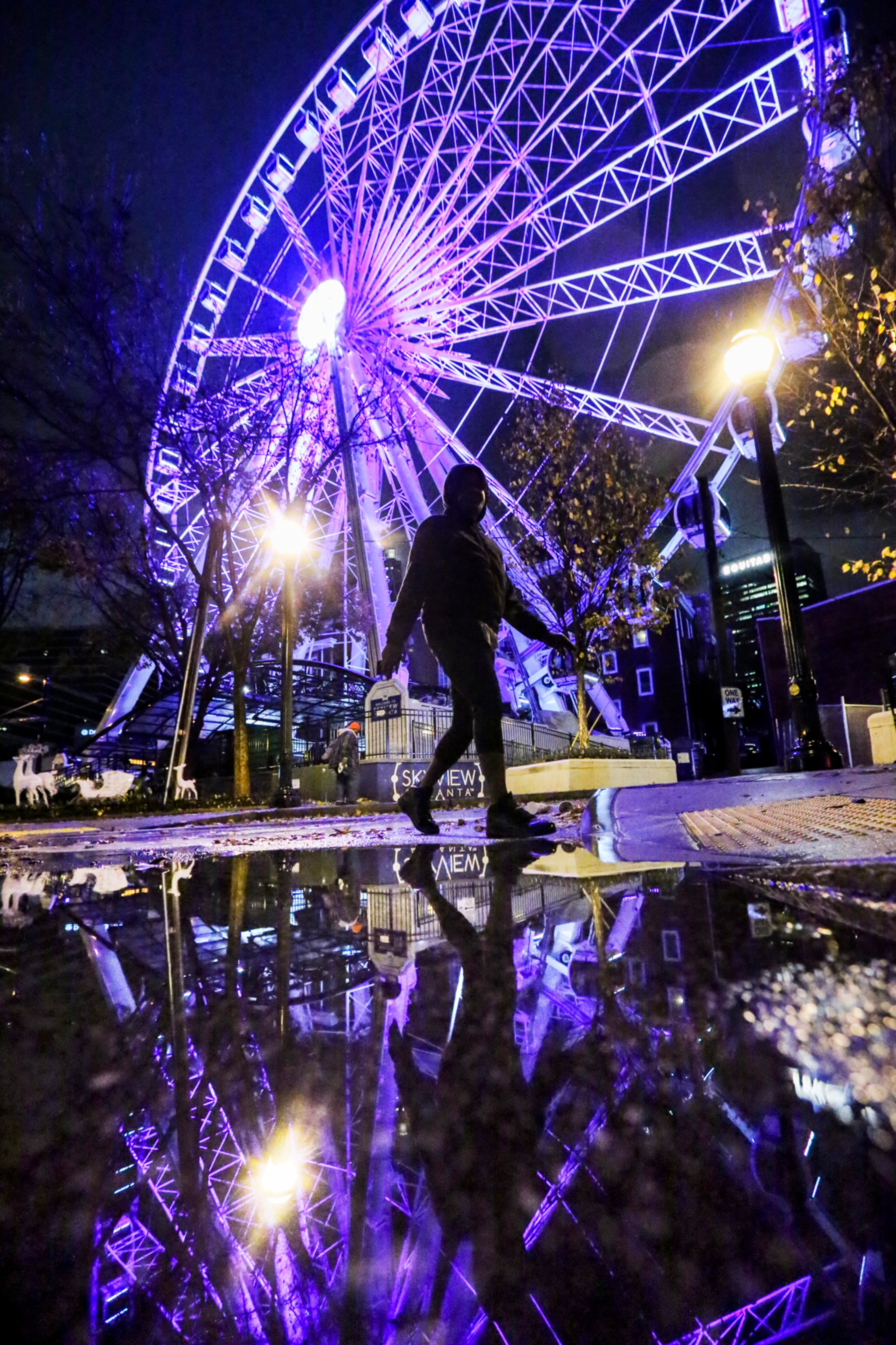 November 29, 2016 Atlanta: The colors of SkyView are reflected in the pooled water along Centennial Olympic Drive Tuesday morning, Nov. 29, 2016 after metro Atlantans saw rain for the first time in more than a month. But that rain led to flooding, standing water on local interstates and "one of the worst rush hours in recent memory," the WSB 24-hour Traffic Centerâs Mark Arum said. Drivers on I-285 in DeKalb County dealt with morning flooding in the left lanes before Bouldercrest Road. It was not the only incident of flooding. Westbound I-20 east of Candler Road in DeKalb County, southbound Ga. 400 past Northridge Road in north Fulton County and westbound on the I-20 ramp to Holmes Drive in Fulton experienced flooding, too. And those heading to Hartsfield-Jackson Atlanta Airport encountered flooding on the southbound I-85 ramp to Camp Creek Parkway in south Fulton County. The Marietta Police Department was so concerned about the rain's impact on traffic, the agency sent out text and online reminders urging drivers to "use caution this morning as they make their daily commute. "Nearly a month of no rain has left the roadways with a large buildup of oil that becomes slippery when wet," the department said in the alert. "Leave yourself more time than usual for your drive and watch for large puddles in the roadway. More than 9,430 people were without power early Tuesday, according to the latest numbers from Georgia Power. JOHN SPINK /JSPINK@AJC.COM