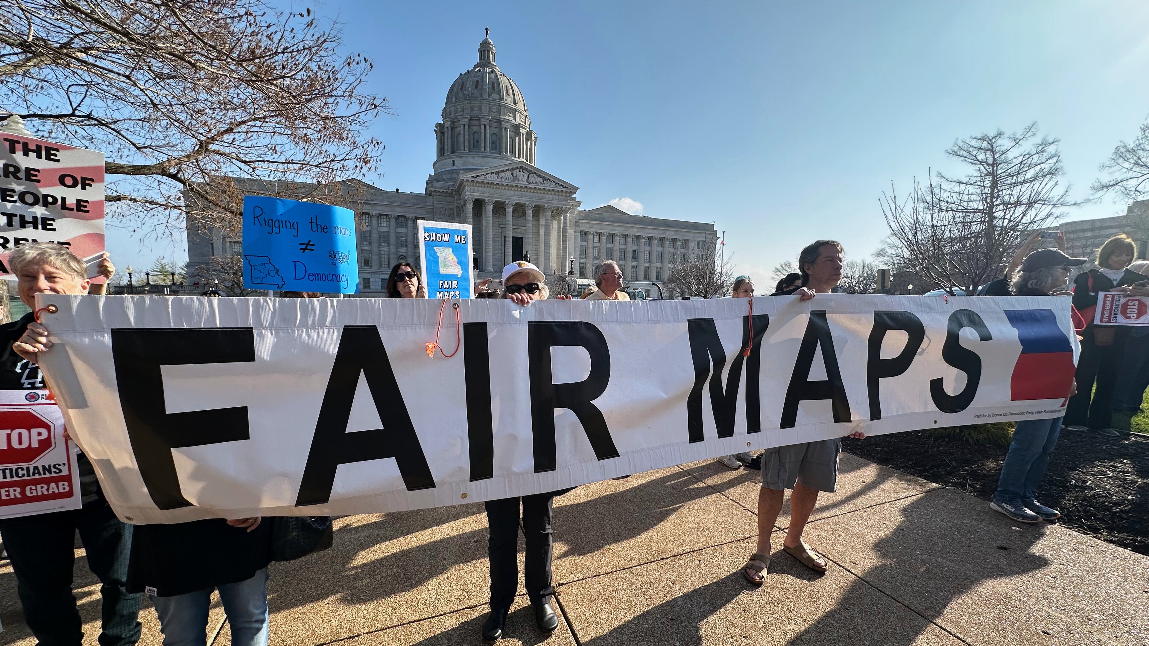 People opposed to new the U.S. House districts passed by the Missouri General Assembly demonstrate outside the state Capitol, in Jefferson City, Mo., Tuesday, March 10, 2026. (AP Photo/David A. Lieb)