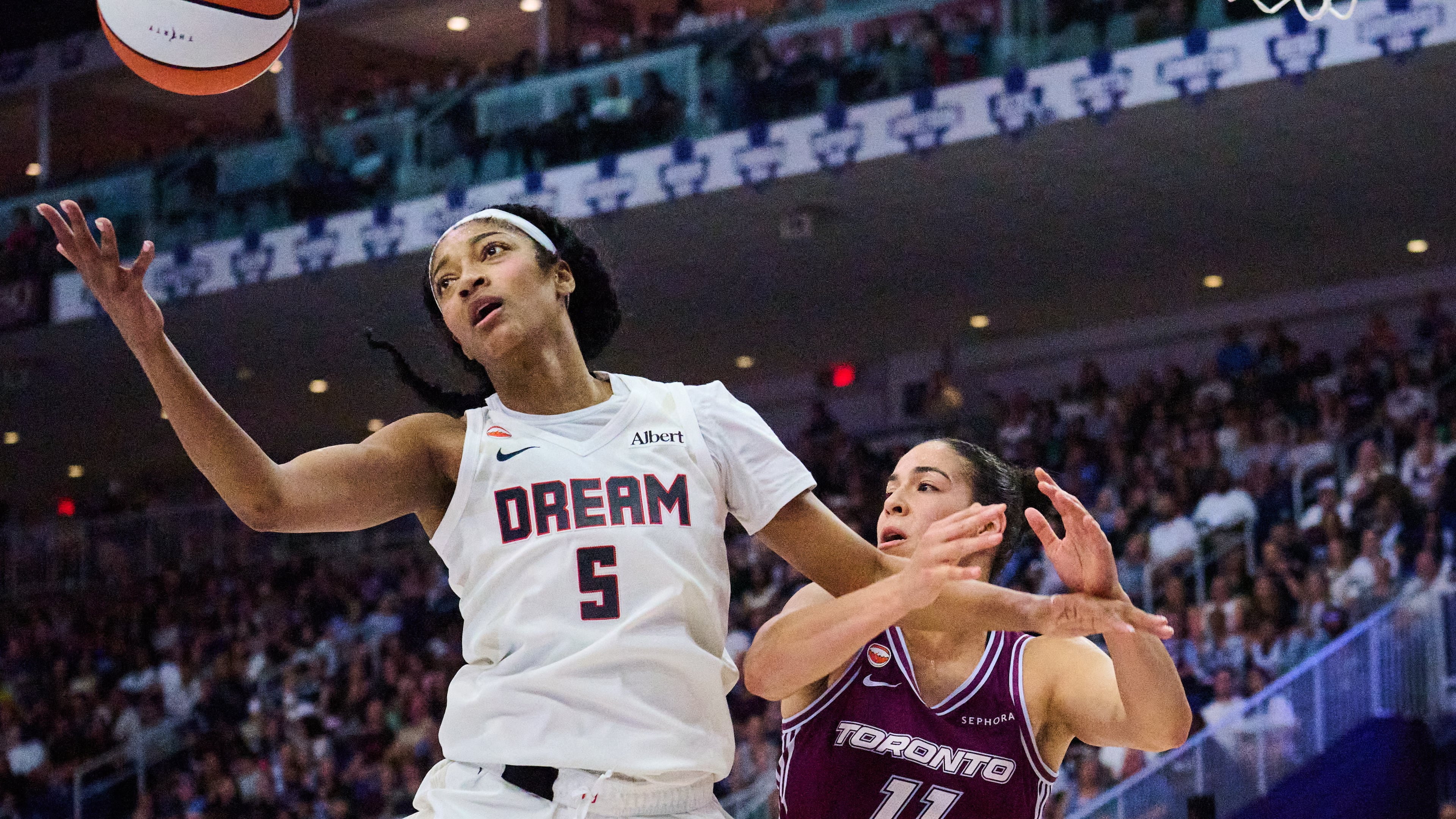 Atlanta Dream's Angel Reese (5) wins a rebound against Toronto Tempo's Kia Nurse, right, during the first half of a WNBA basketball game in Toronto, Friday, July 17, 2026. (Sammy Kogan/The Canadian Press via AP)