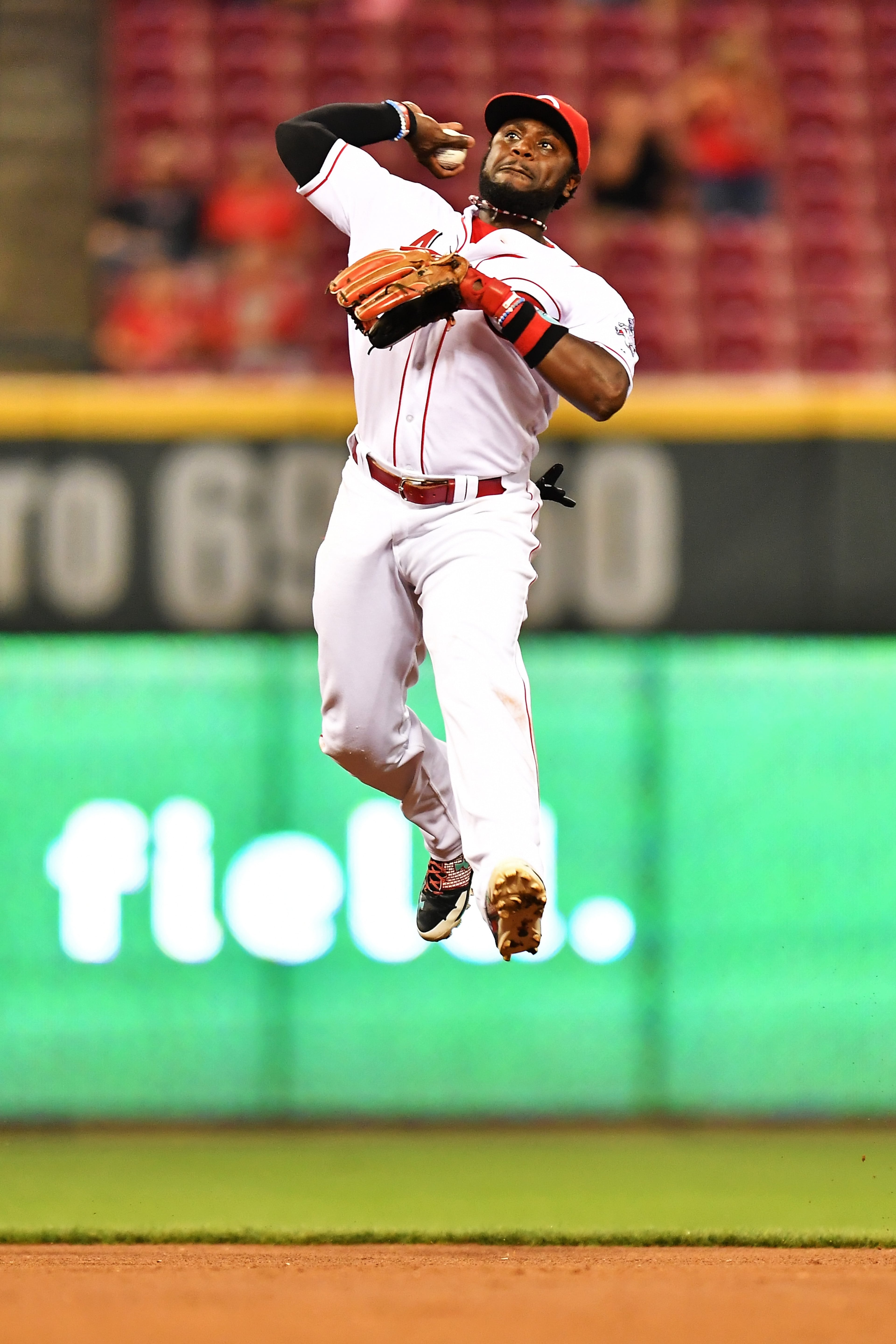 CINCINNATI, OH - AUGUST 17: Brandon Phillips #4 of the Cincinnati Reds makes a leaping throw to first base to throw out Dee Gordon #9 of the Miami Marlins in the fifth inning at Great American Ball Park on August 17, 2016 in Cincinnati, Ohio. Cincinnati defeated Miami 3-2. (Photo by Jamie Sabau/Getty Images)