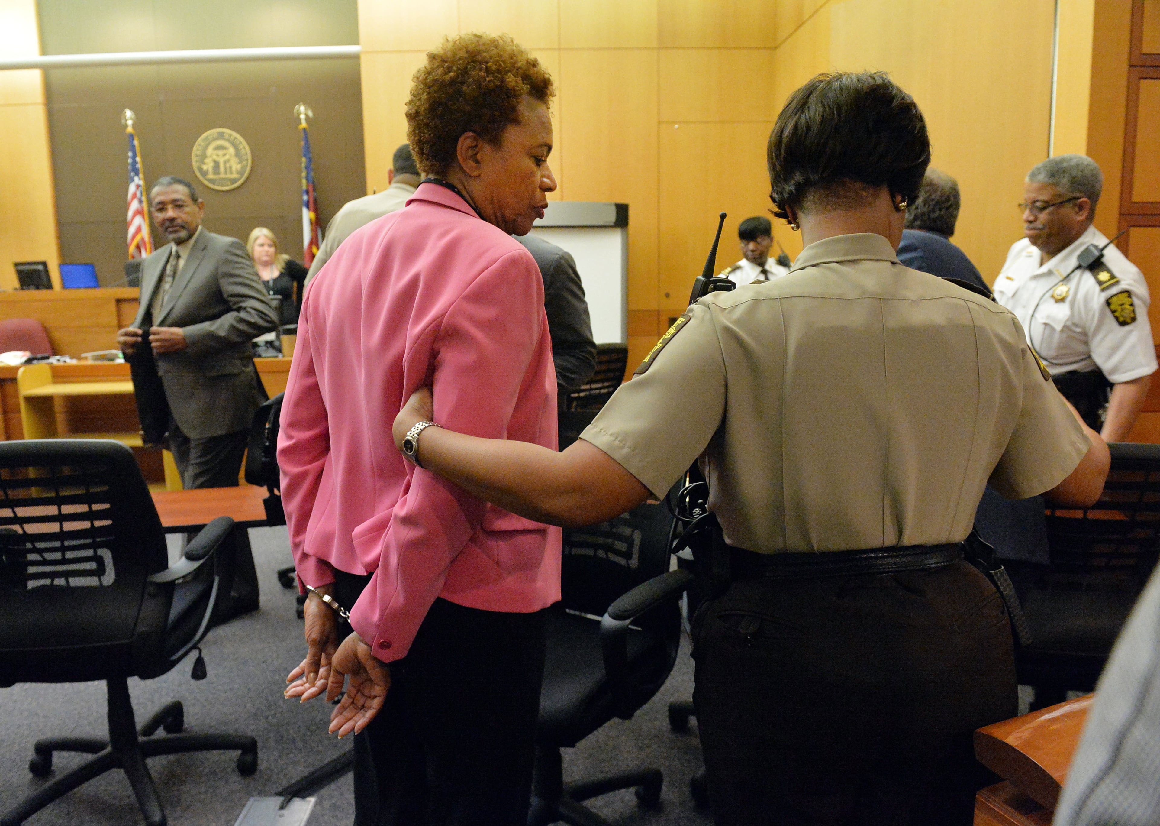 Former APS SRT Director Sharon Davis Williams is led to a holding cell following her conviction on Violation of Racketeer Influenced and Corrupt Organizations Act charges Wednesday. A jury of six men and six women rendered their verdicts on the eighth day of deliberations in the Atlanta Public Schools test-cheating trial on Wednesday, April 1, 2015. Jurors sorted through roughly five months of testimony against 12 former educators accused of engaging in a racketeering conspiracy to inflate test scores. (Atlanta Journal-Constitution, Kent D. Johnson, Pool)
