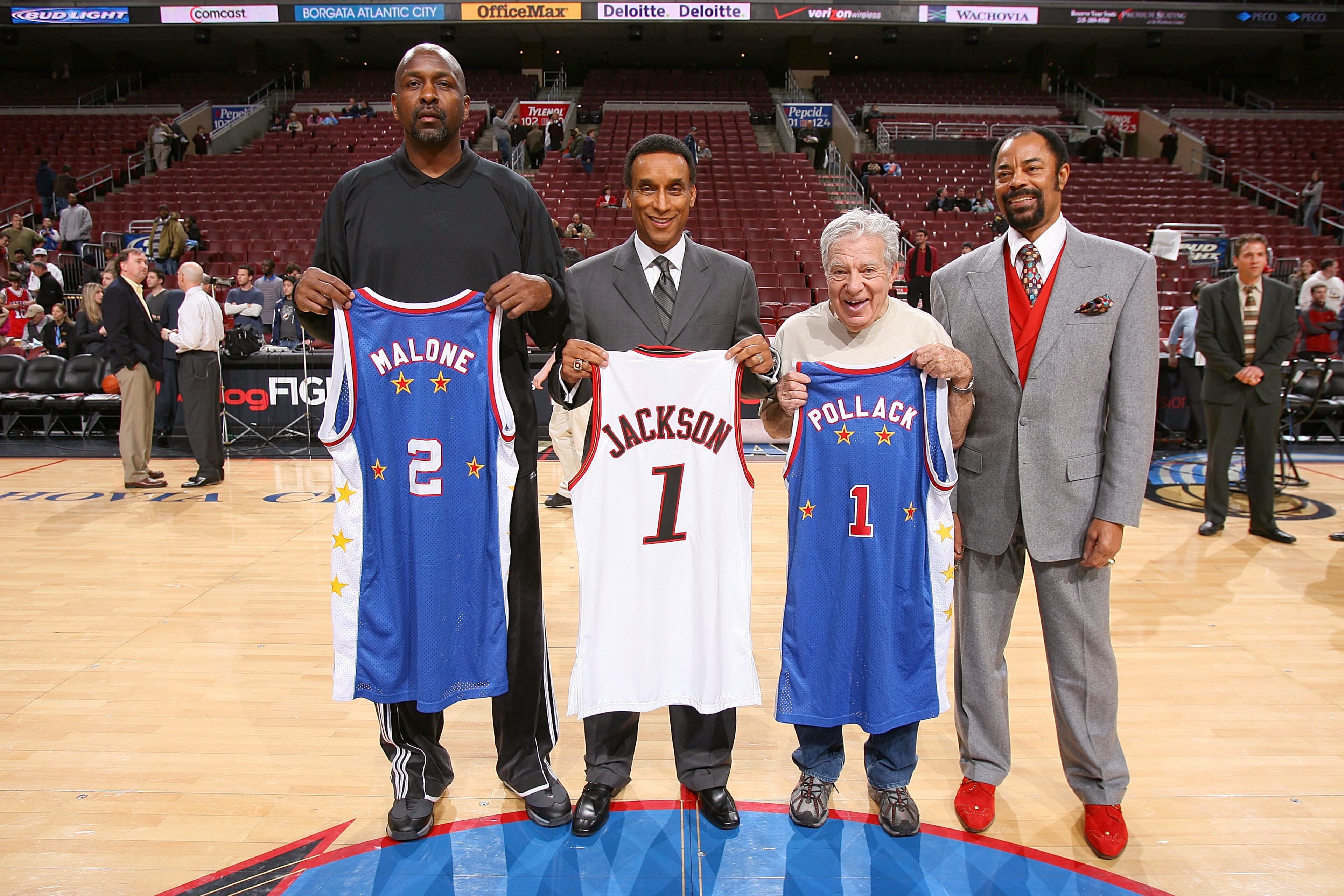 PHILADELPHIA - FEBRUARY 21: (L-R) Moses Malone, Philadelphia 76ers legend and current Assistant Coach; Mannie Jackson, Chairman of the Hall of Fame Harlem Globetrotters; Harvey Pollack, Philadelphia 76ers Director of Statistical Information; and Walter "Clyde" Frazier, former NBA player and current commentator for the New York Knicks telecasts, pose for a photograph before the game between the New York Knicks and the Philadelphia 76ers on February 21, 2007 at the Wachovia Center in Philadelphia, Pennsylvania. NOTE TO USER: User expressly acknowledges and agrees that, by downloading and or using this Photograph, user is consenting to the terms and conditions of the Getty Images License Agreement. Mandatory Copyright Notice: Copyright 2007 NBAE (Photo by Jesse D. Garrabrant/NBAE via Getty Images)