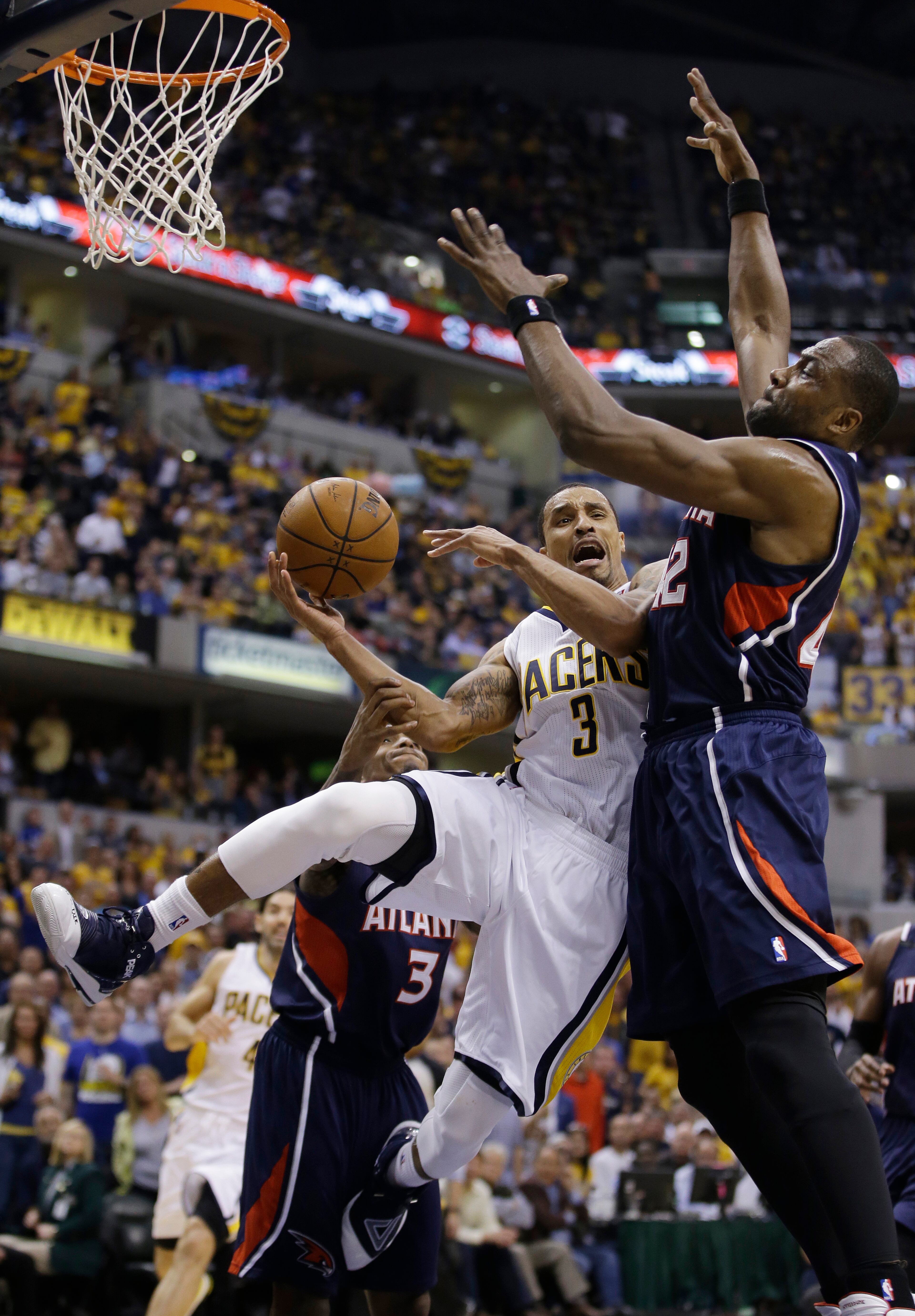 Indiana Pacers' George Hill (3) is fouled by Atlanta Hawks' Elton Brand as he goes up of a shot during the second half in Game 2 of an opening-round NBA basketball playoff series Tuesday, April 22, 2014, in Indianapolis. Indiana defeated Atlanta 101-85. (AP Photo/Darron Cummings)