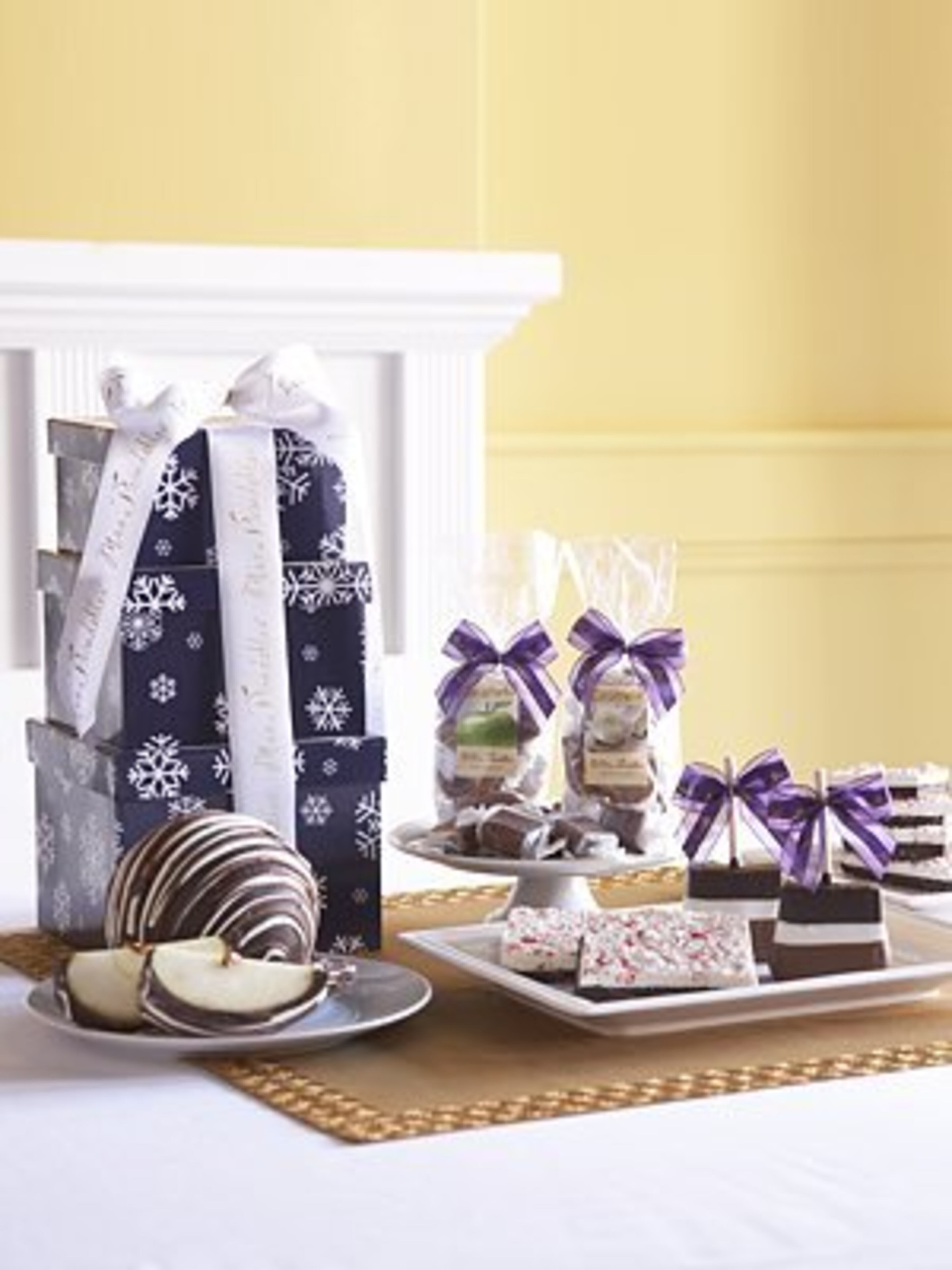 Mrs. Prindable's Snowflake Tower, $50. A winter fantasy of crisp apple, chocolate and caramel treats, beautifully packaged and ready to give. Three boxes decorated with delicate snowflakes and white ribbon.