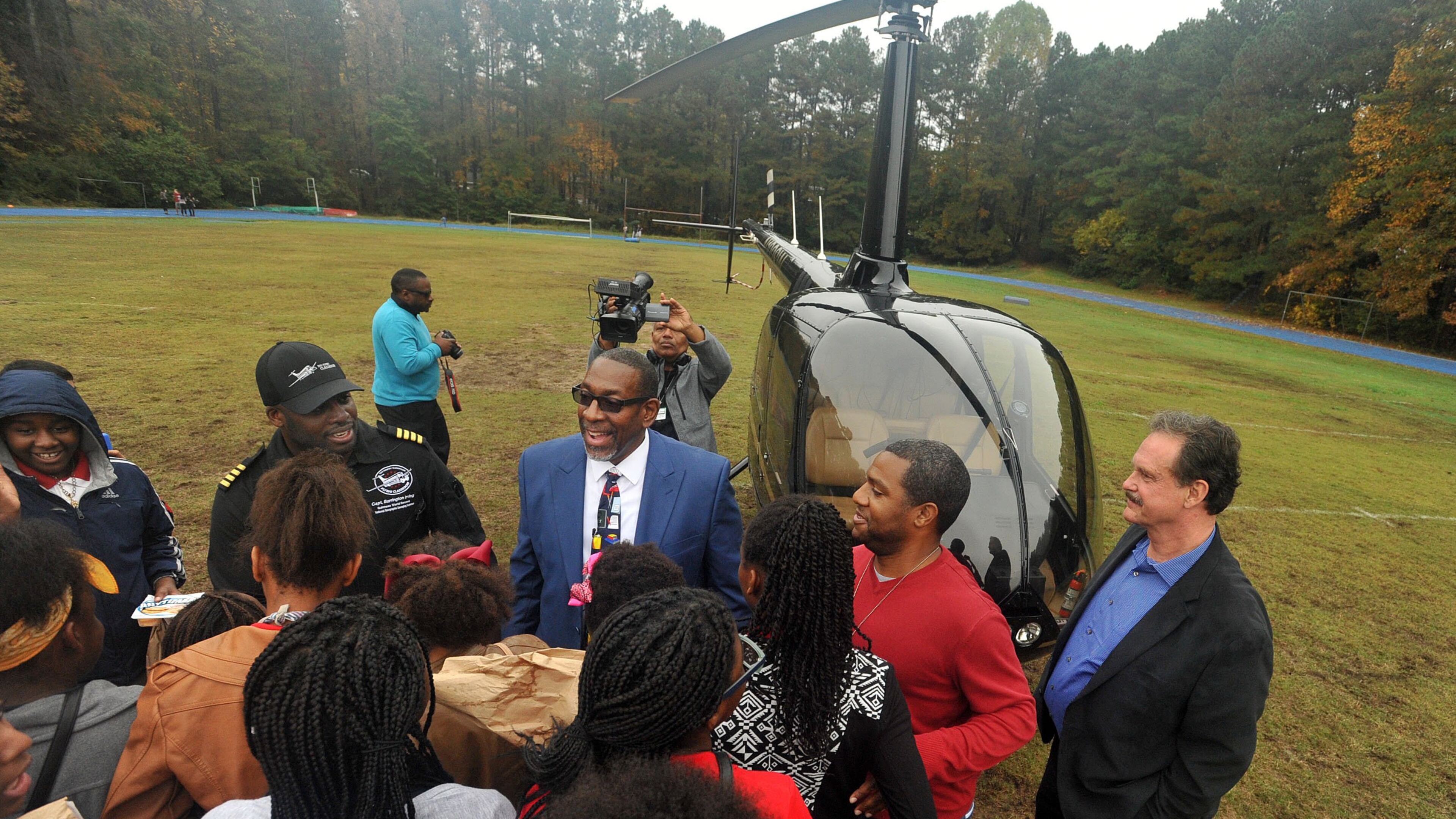 DeKalb Country Schools Superintendent Steve Green (right) and Captain Barrington Irving of The Flying Classroom and Experience Aviation talk with Stone Mountain Middle School students. KENT D. JOHNSON/KDJOHNSON@AJC.COM