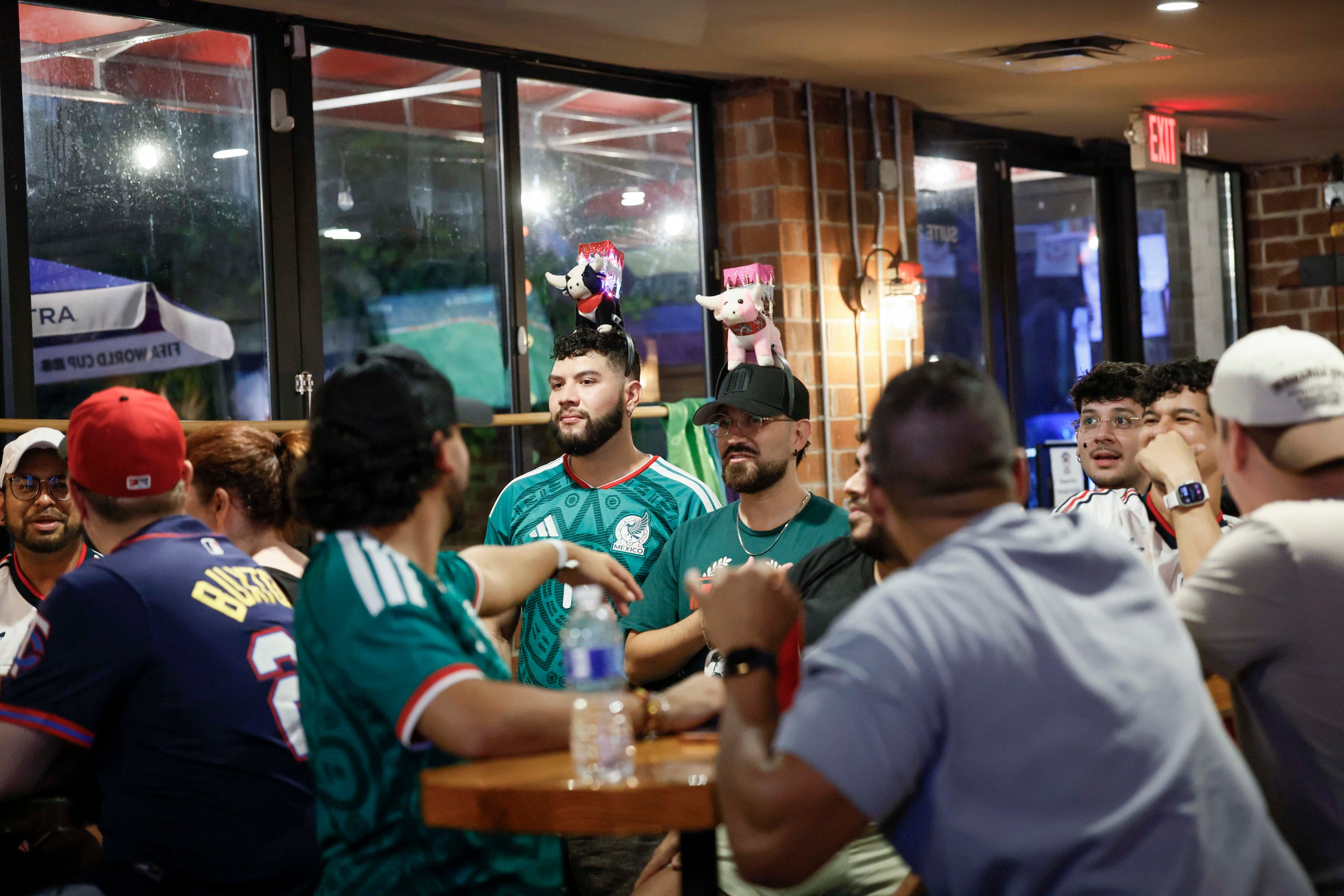 A group of customers watch a World Cup game on screens at Woofs Sport Bar. “You don’t have to worry about not being yourself (there),” says Joshua Hill, the communications director for All Stripes, Atlanta United’s LGBTQ supporter group. (Miguel Martinez/AJC)