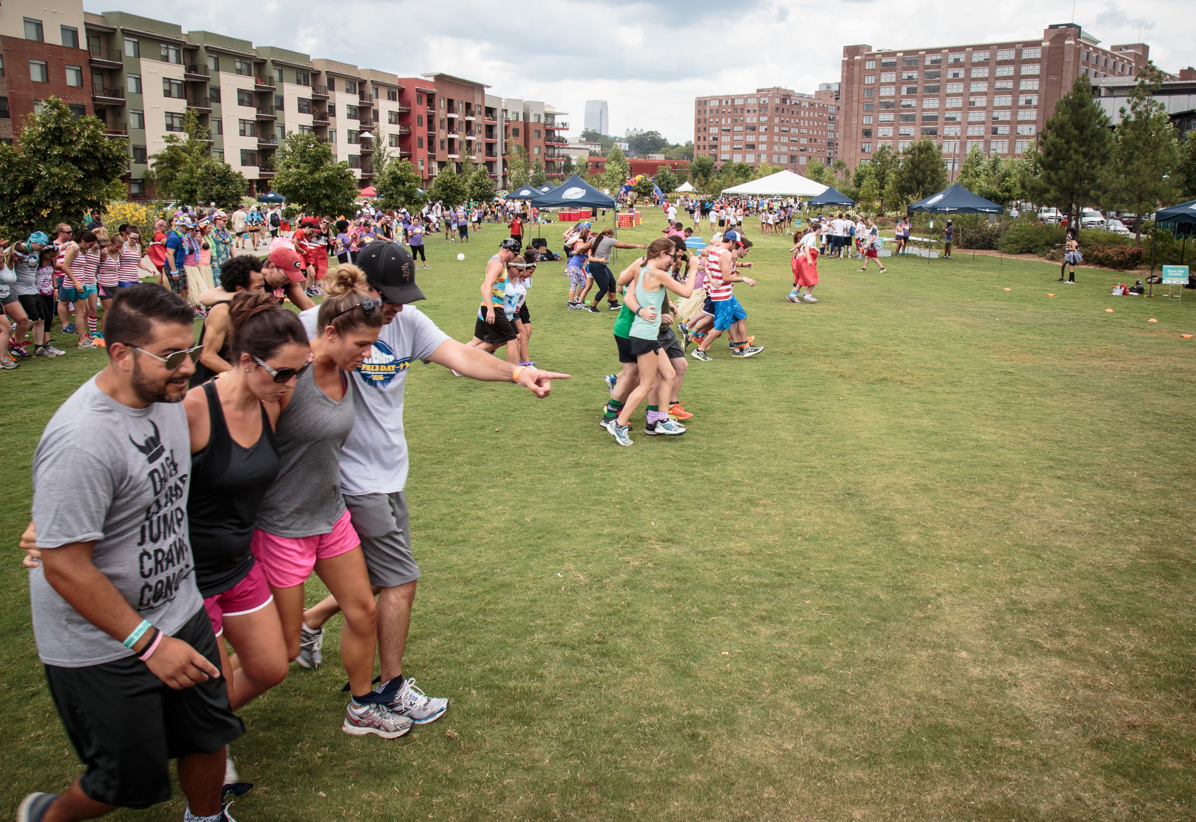 Teams shuffle across the Historic Fourth Ward Park during the Five legged Race during Atlanta Field Day in Atlanta, Ga. Saturday, July 16, 2016. 92 teams participated in this year's events. STEVE SCHAEFER / SPECIAL TO THE AJC
