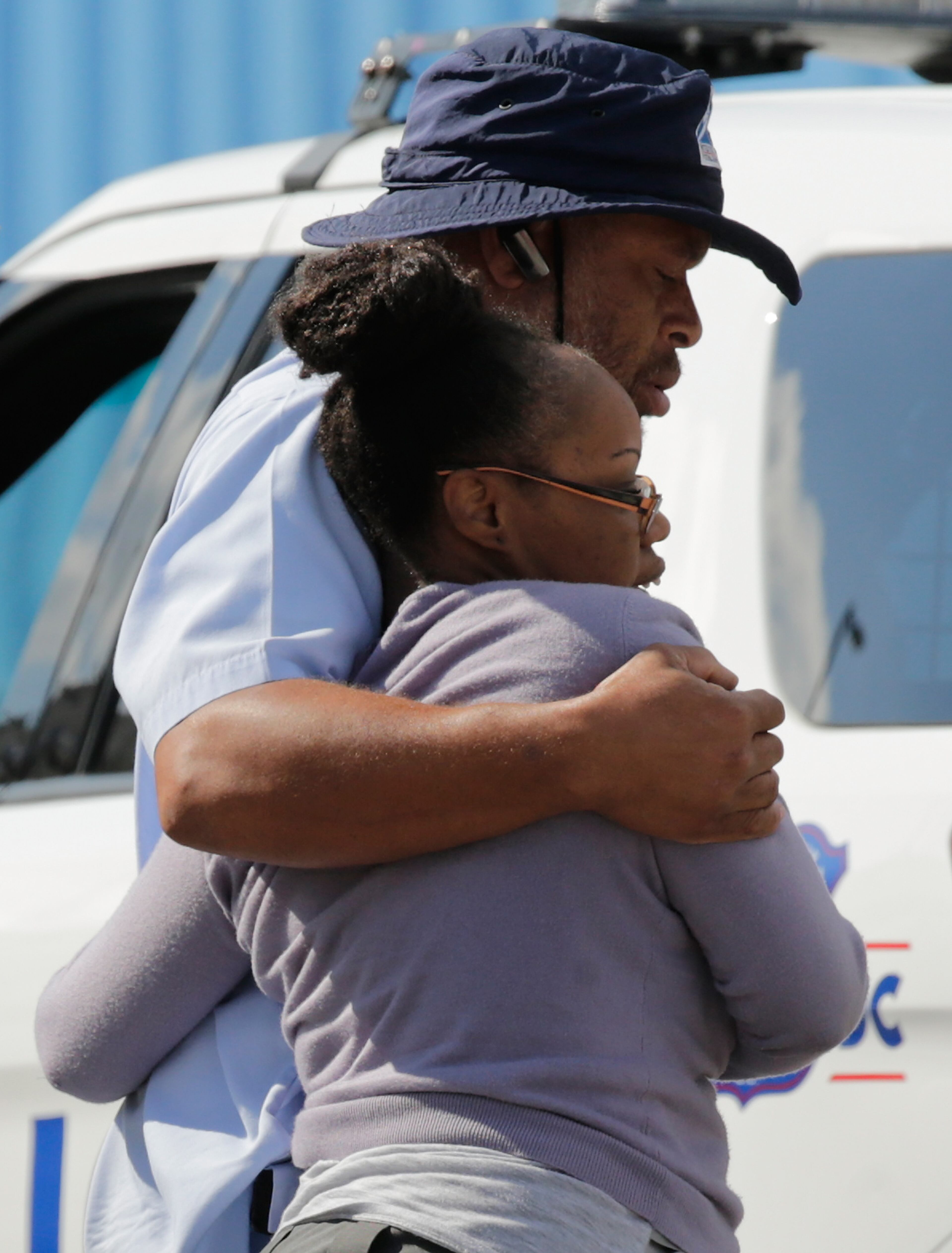 After a bus dropped off employees recently released from the Navy Yard complex, a couple walks away from a gathering point for families that was set up inside Nationals Park in the wake of the Navy Yard shooting Sept. 16, 2013, in Washington, D.C.