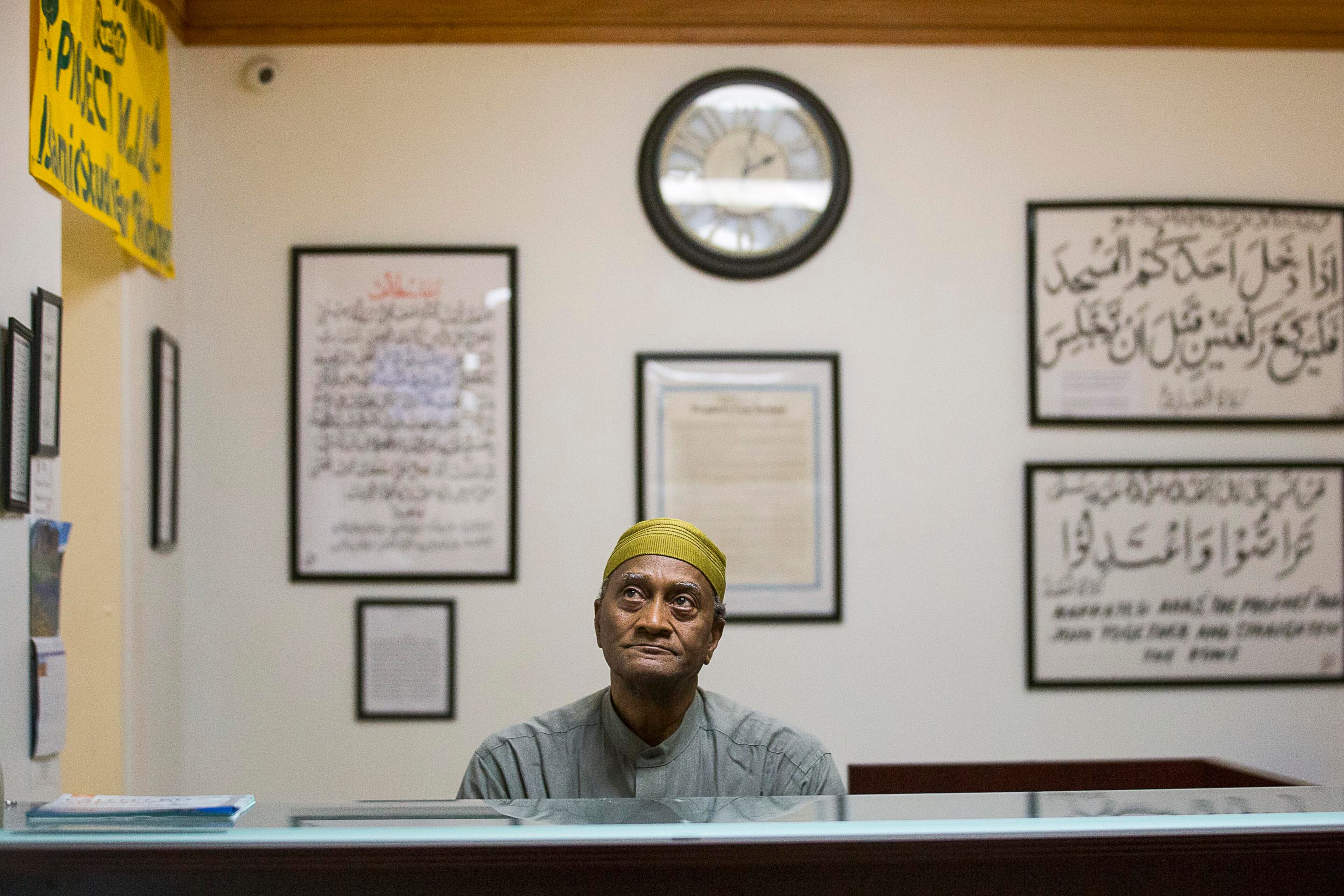 Abdulkarim S. Muhammad watches multiple security cameras on a screen during the Jum'ah Friday prayer at the Masjid Al-Mu'minun mosque in Atlanta's Peoplestown neighborhood, Friday, March 15, 2019. Muhammad mans a desk at the mosque where he checks large bags and reminds members of the congregation to turn off their cell phones.