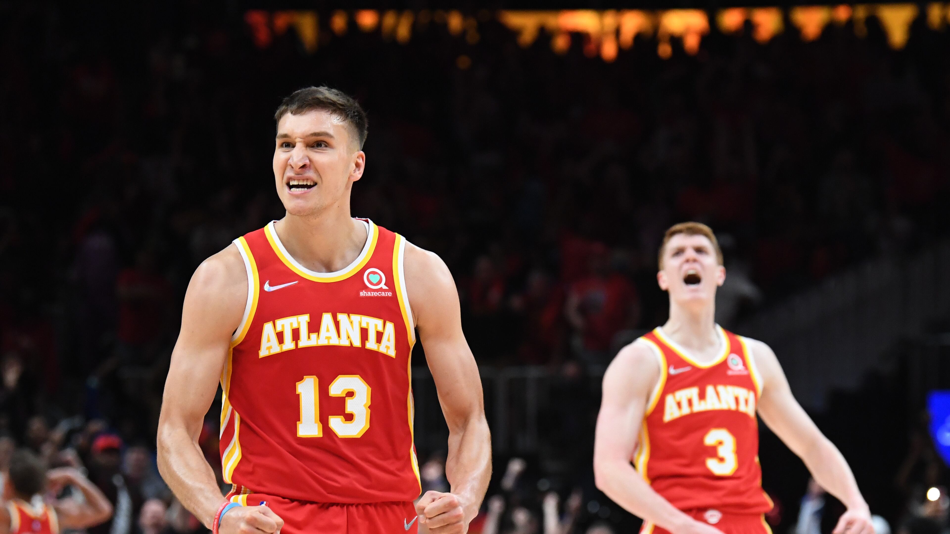 Hawks Bogdan Bogdanovic (left) and Kevin Huerter celebrate during a win over the Heat. (Hyosub Shin / Hyosub.Shin@ajc.com)