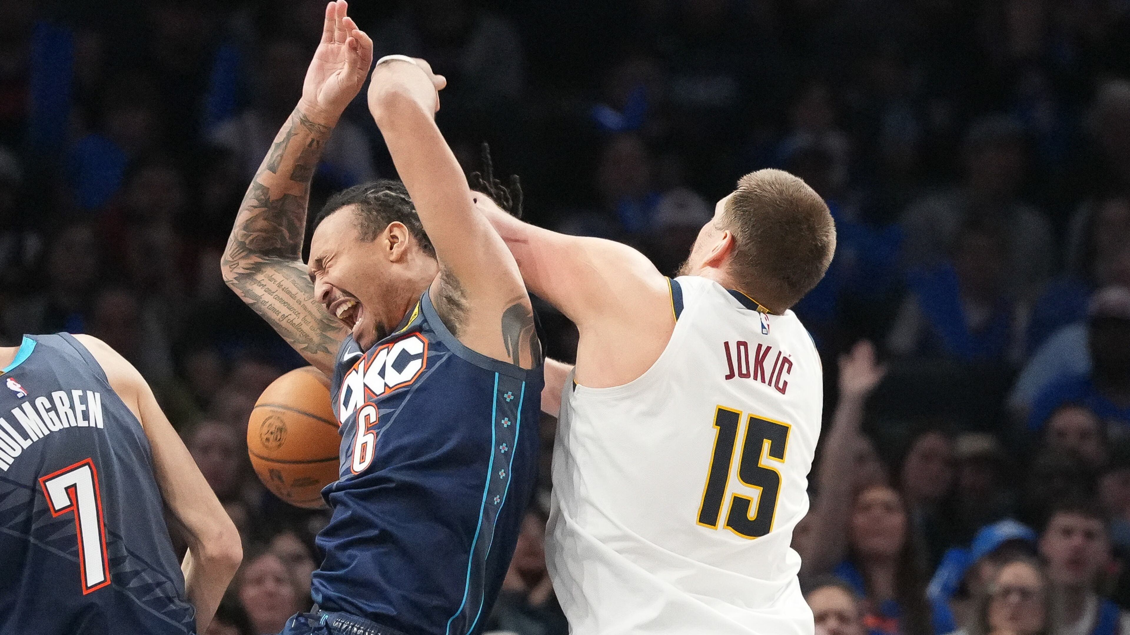 Oklahoma City Thunder forward Jaylin Williams (6) falls into Denver Nuggets center Nikola Jokic (15) as he goes after a rebound during the second half of an NBA basketball game, Friday, Feb. 27, 2026, in Oklahoma City. (AP Photo/Kyle Phillips)