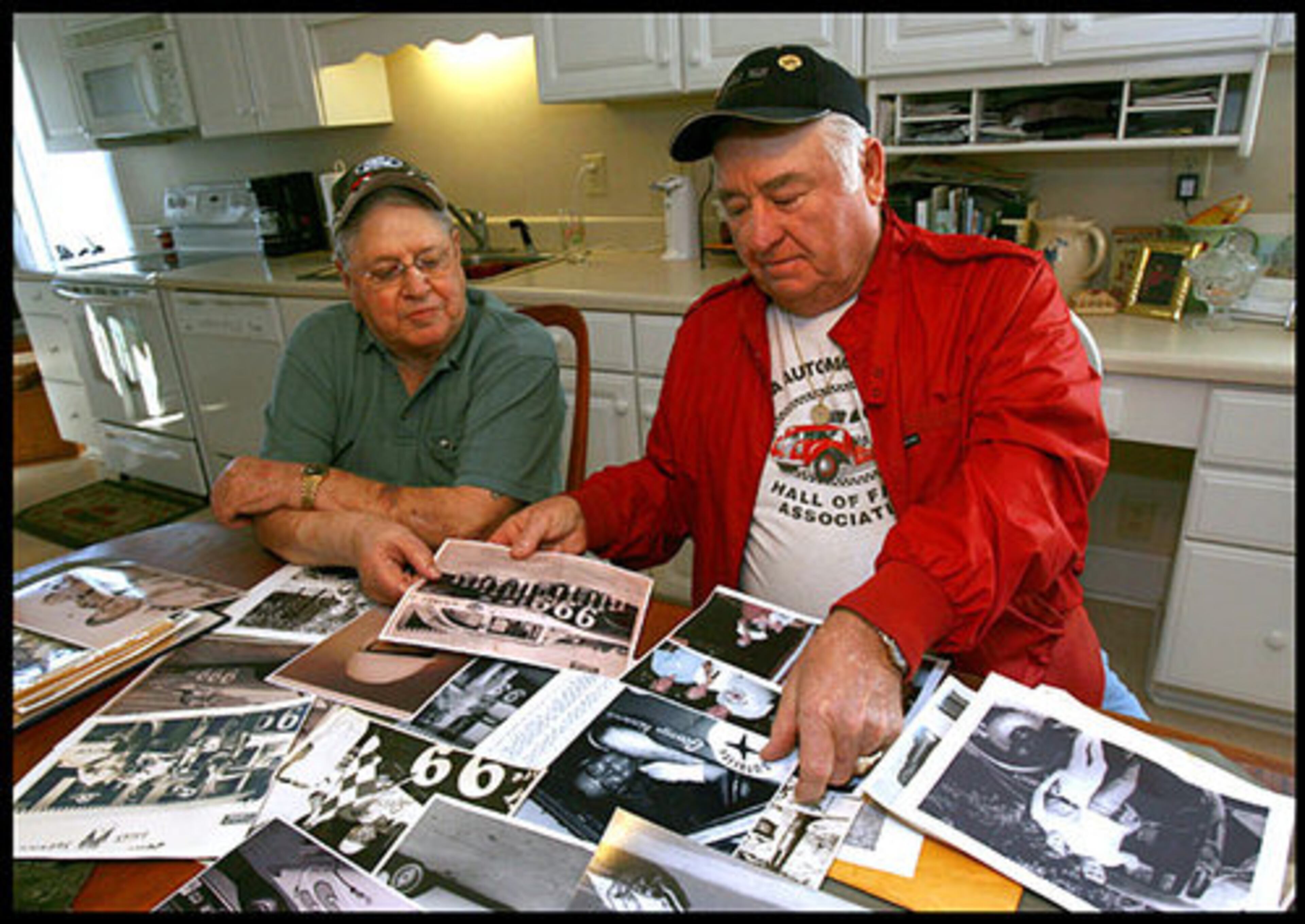 Wilbur Rakestraw and George Alsobrook look through photos of their racing days during the Daytona 500 in '59, and other races in the 1960's.