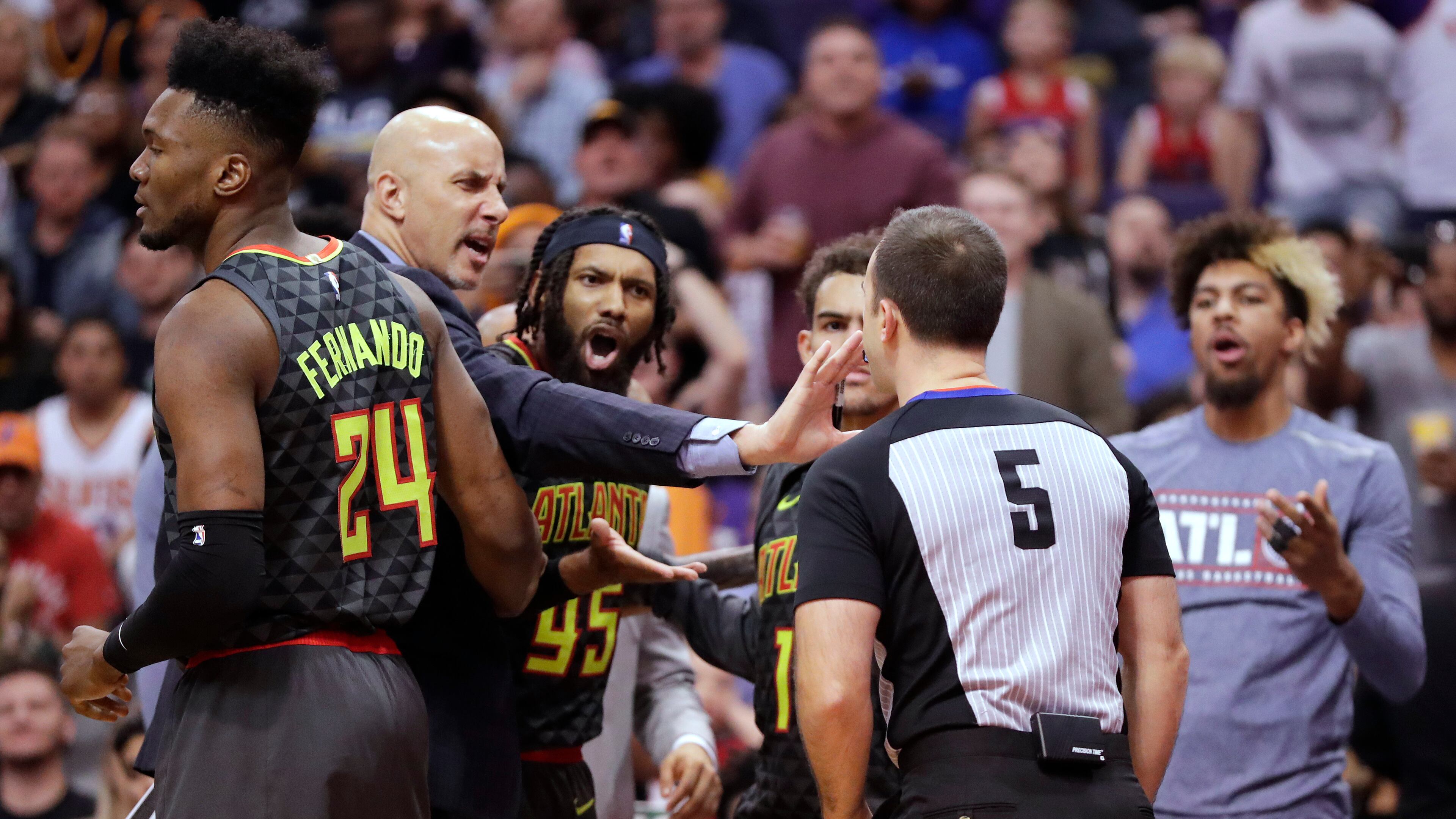 Referee Kane Fitzgerald ejects Hawks guard DeAndre' Bembry (middle) during the second half. (AP Photo/Matt York)