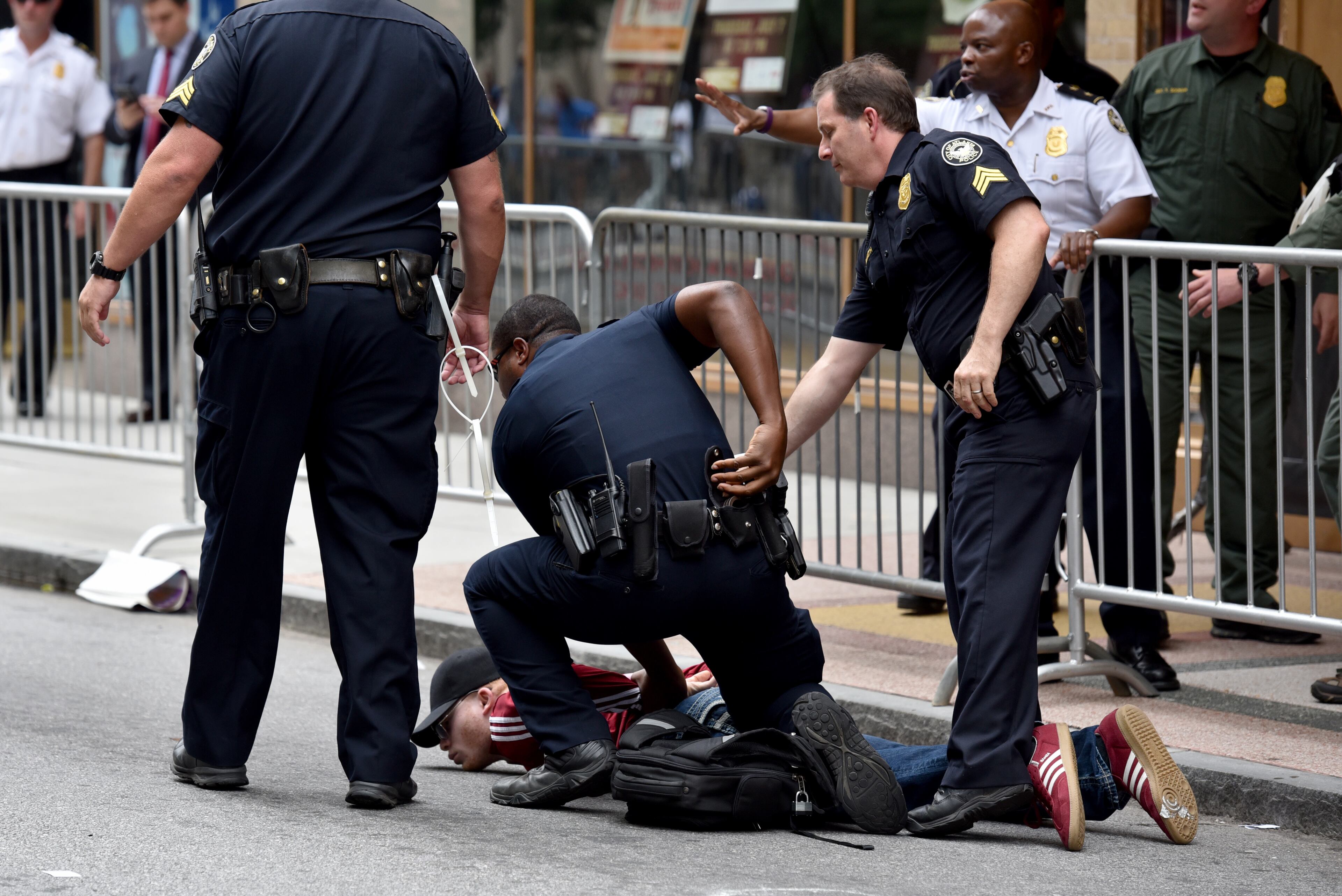 Atlanta police arrest a protester outside a Donald Trump rally at the Fox Theatre on Wednesday, June 15, 2016. At least three people were arrested for allegedly harassing a Trump supporter who was leaving the event. BRANT SANDERLIN/BSANDERLIN@AJC.COM