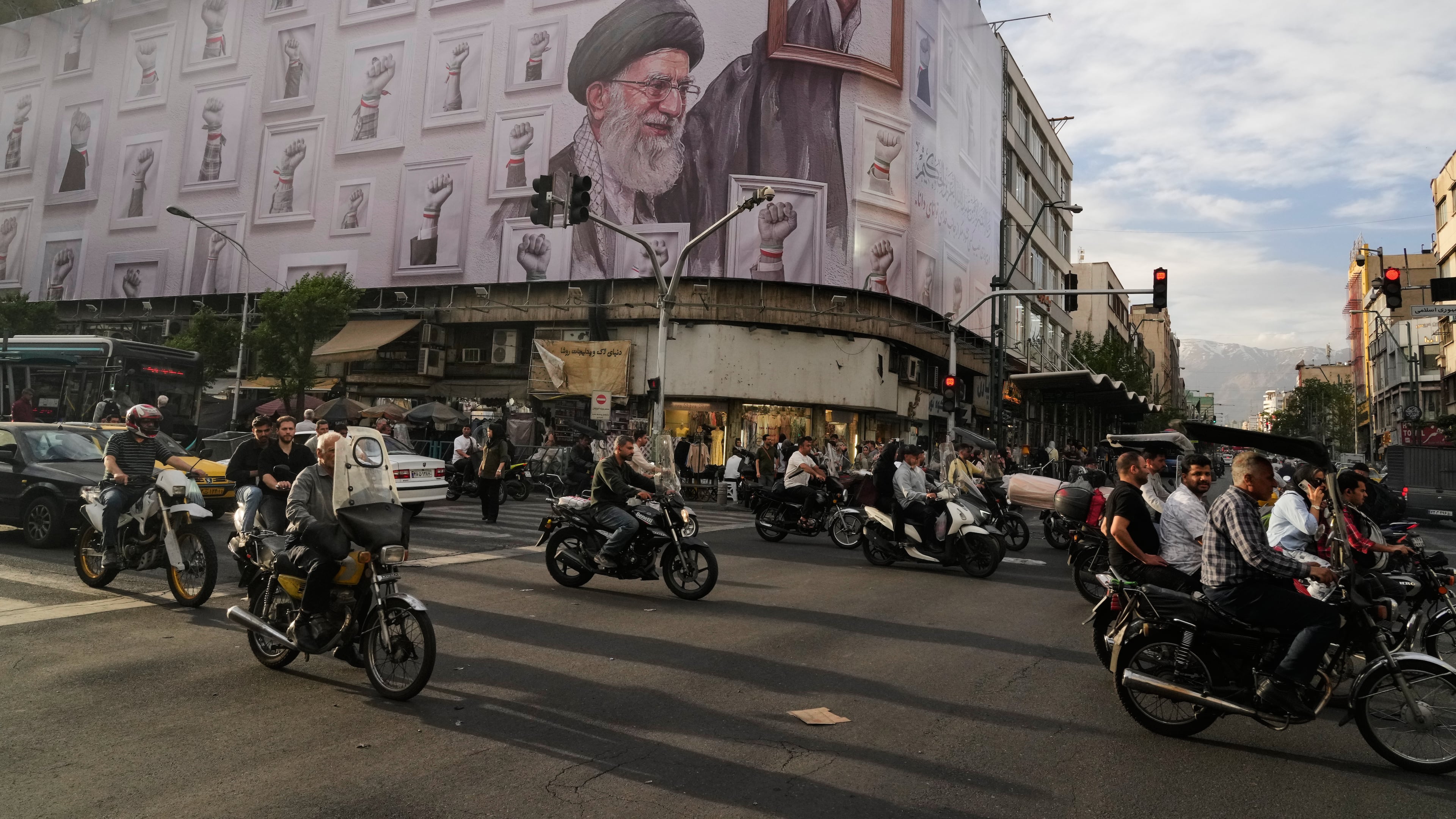FILE - Motorbikes drive past a billboard showing the late Iranian Supreme Leader Ayatollah Ali Khamenei, who was killed in the U.S. and Israel strikes on Feb. 28, in downtown Tehran, Iran, Wednesday, May 6, 2026. (AP Photo/Vahid Salemi, File)