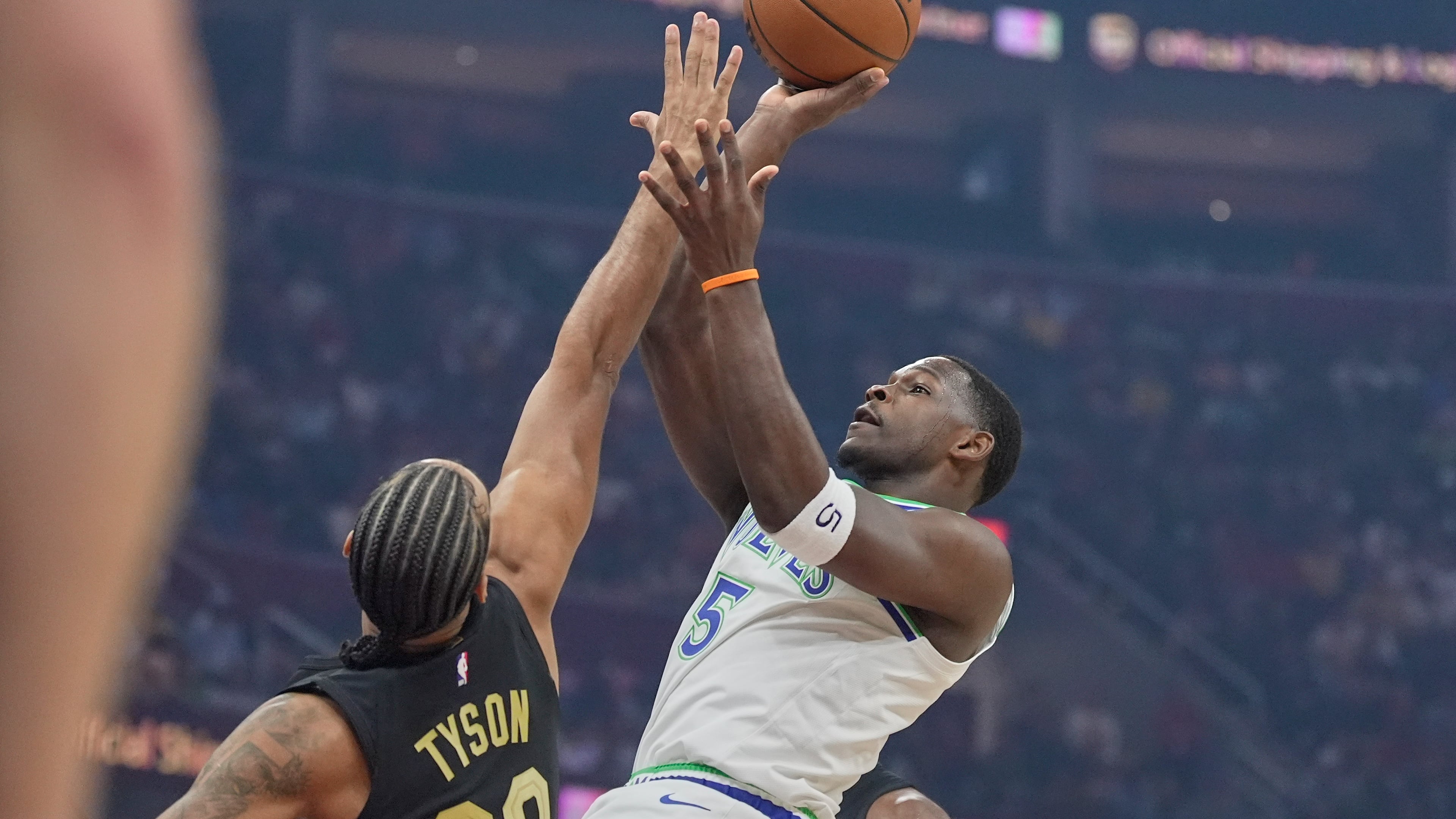 Minnesota Timberwolves guard Anthony Edwards (5) shoots as Cleveland Cavaliers guard Jaylon Tyson (20) defends in the first half of an NBA basketball game, Monday, Oct. 26, 2026, in Cleveland. (AP Photo/Sue Ogrocki)