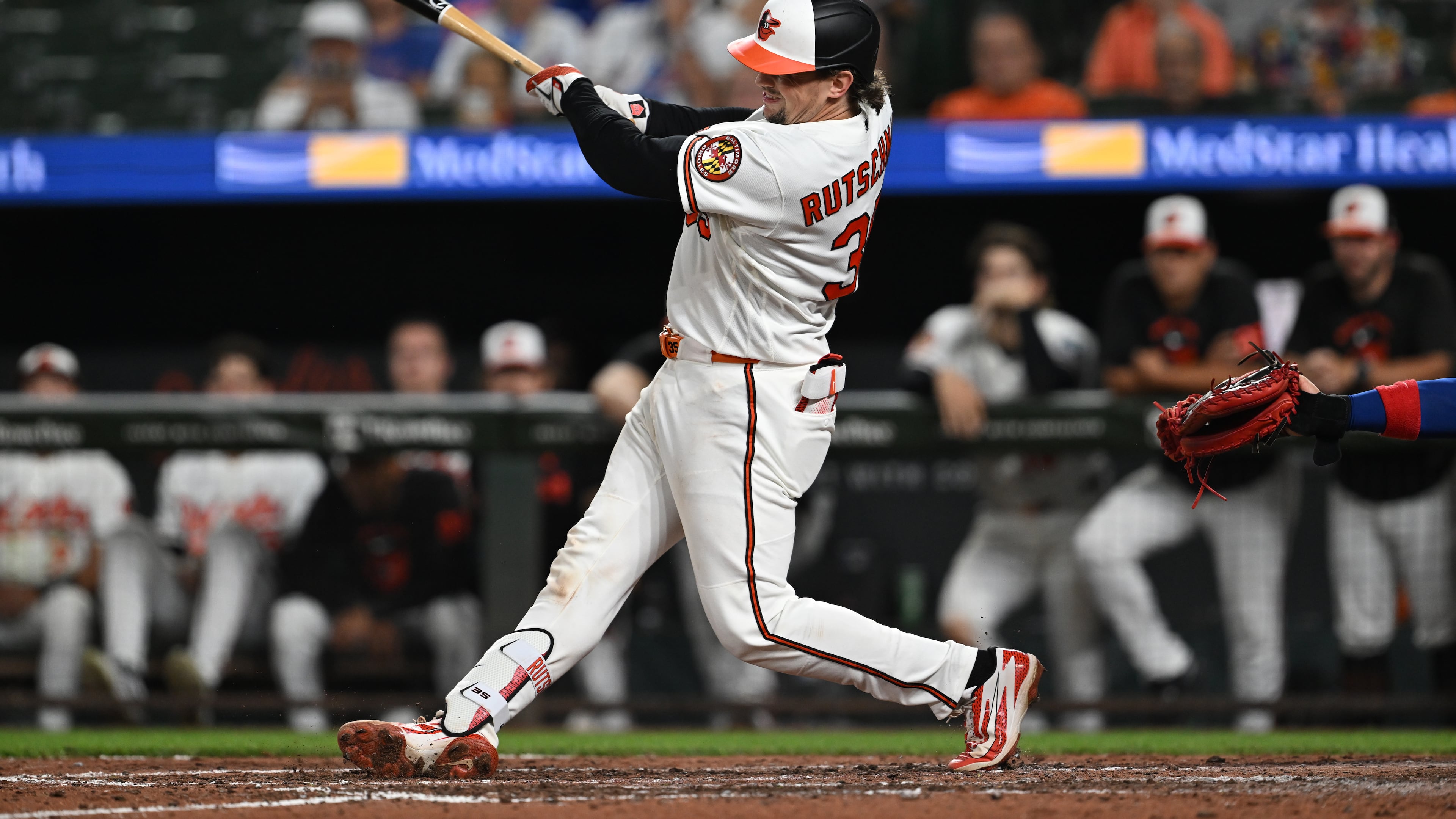 Baltimore Orioles catcher Adley Rutschman (35) follows through on a two run double against the Chicago Cubs in the seventh inning of a baseball game on Tuesday, July 7, 2026 in Baltimore, Md. (AP Photo/Gail Burton)