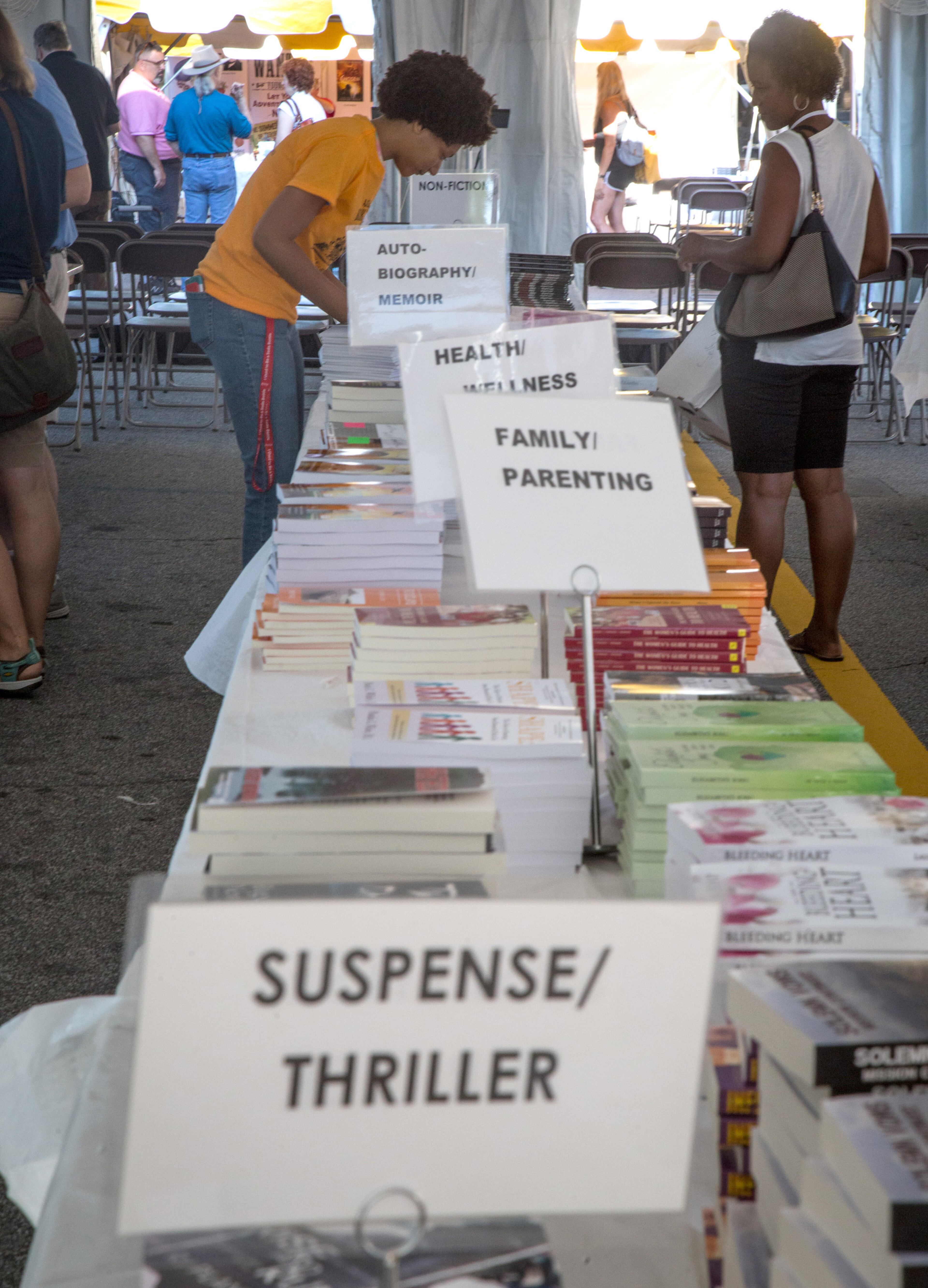 Volunteer Adena Adams (center) organizes some of the many books at the Emerging Writers Tent at the AJC Decatur Book Festival on Saturday, September 1, 2018. The festival kicked off Friday night and continues Sunday. (Photo: STEVE SCHAEFER / SPECIAL TO THE AJC)