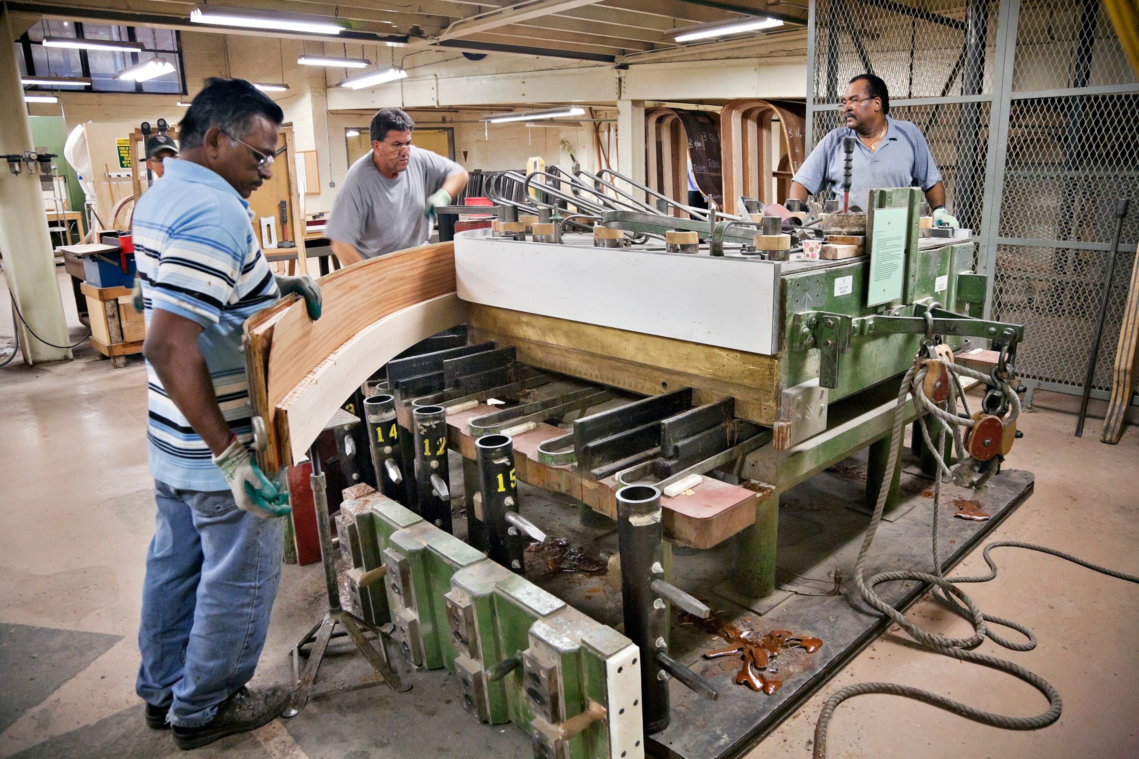 This undated photo provided by Steinway & Sons shows factory craftsmen working at the rim-bending process at the Steinway piano factory, located in the Astoria section of the Queens borough of New York City. The factory offers tours to the public but reservations fill up and must be made months in advance. The industrial heritage of Astoria and the adjacent neighborhood of Long Island City is part of what makes the area an interesting place to visit. Tourists can also enjoy the area's museums, waterfront parks, ethnic food and moderately priced hotels.