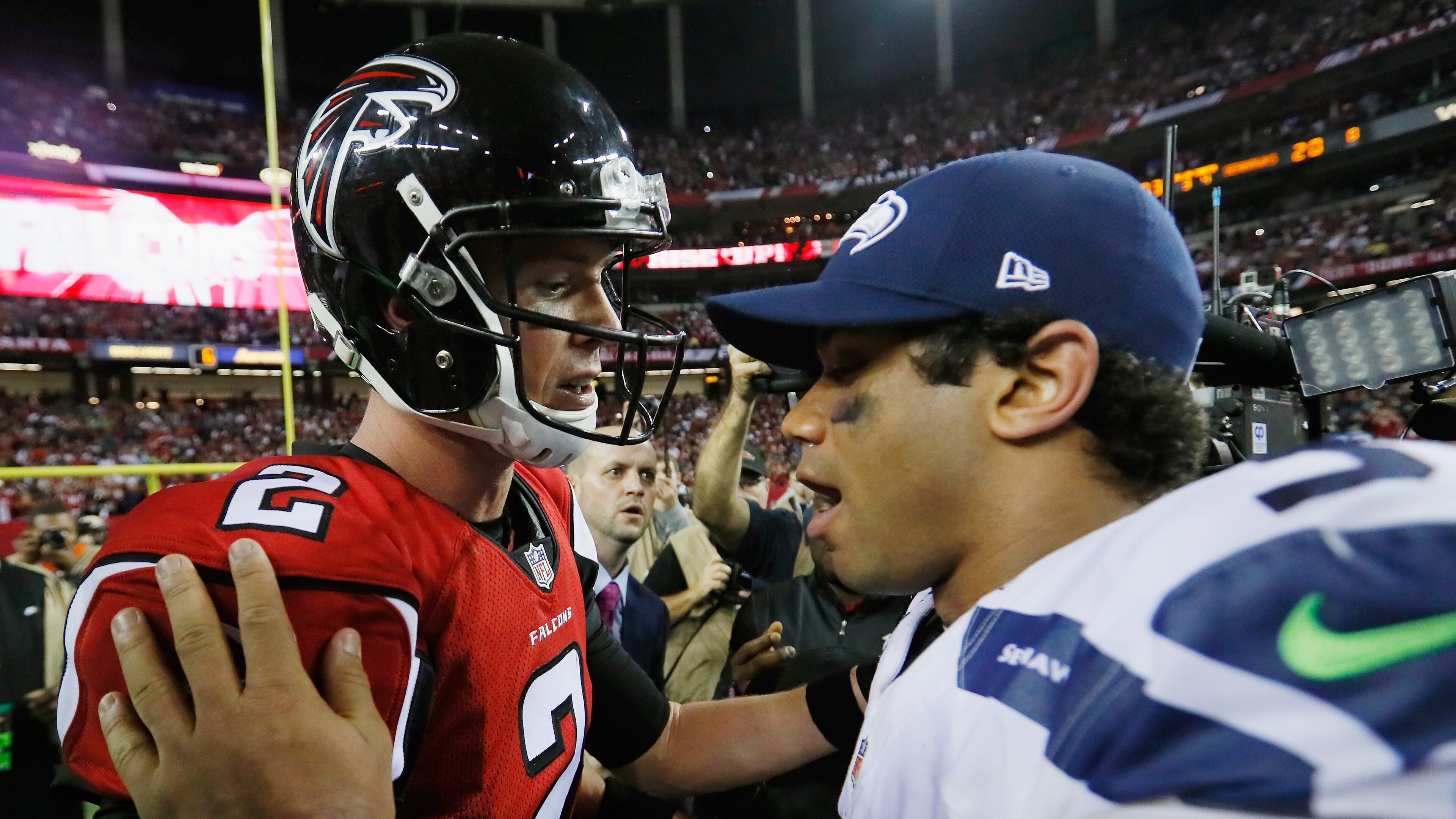 Matt Ryan #2 of the Atlanta Falcons and Russell Wilson #3 of the Seattle Seahawks meet on the field after the Atlanta Falcons win at the Georgia Dome on January 14, 2017 in Atlanta, GA. (Kevin C. Cox/Getty Images/TNS)