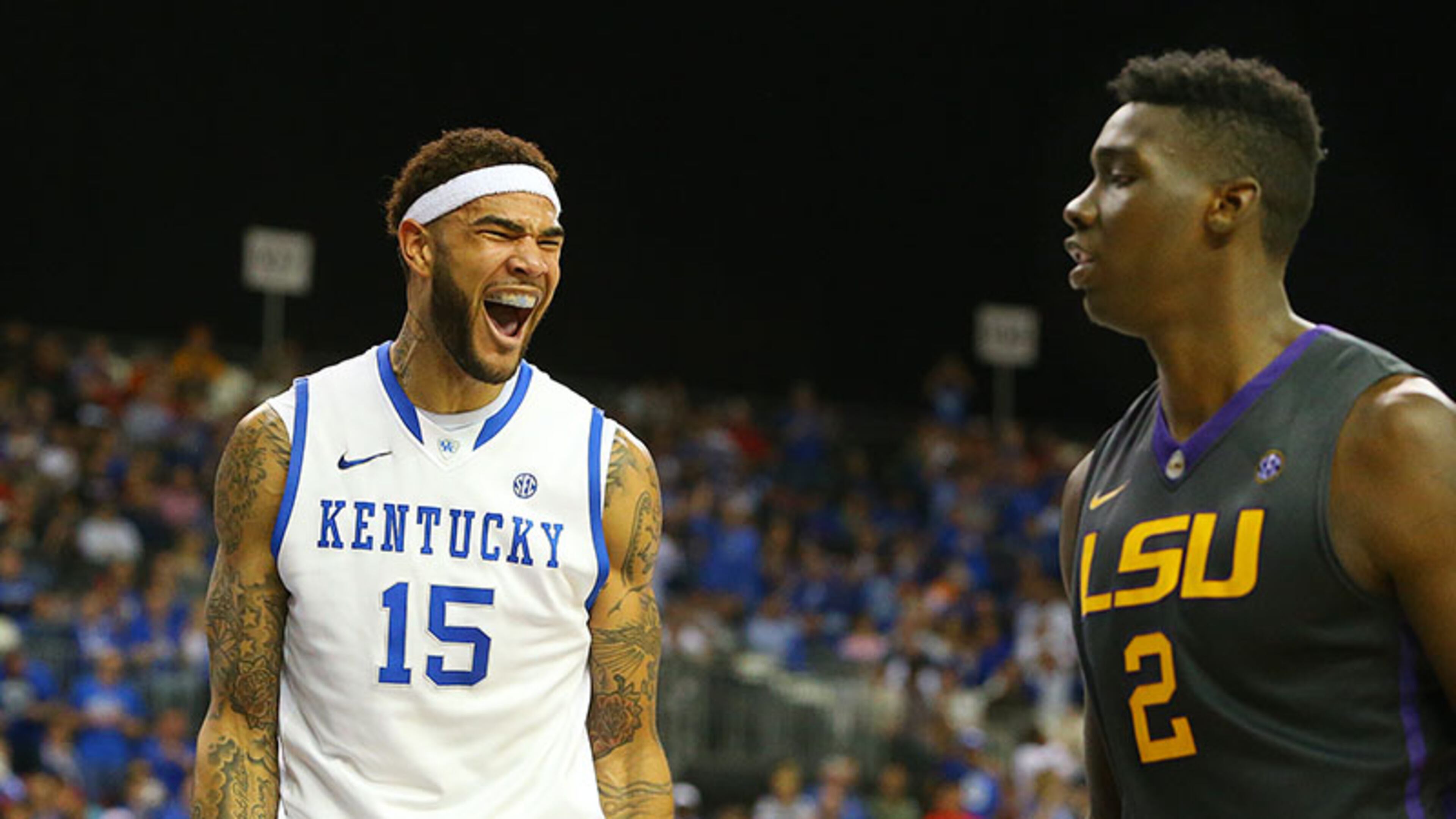 Kentucky forward Willie Cauley-Stein celebrate a slam over LSU forward Jordan Mickey while LSU forward Johnny O'Bryant III looks during the second half of an 85-67 Kentucky win over the Tigers in their SEC quarterfinals matchup Saturday, March 15, 2014, at the Georgia Dome in Atlanta.
