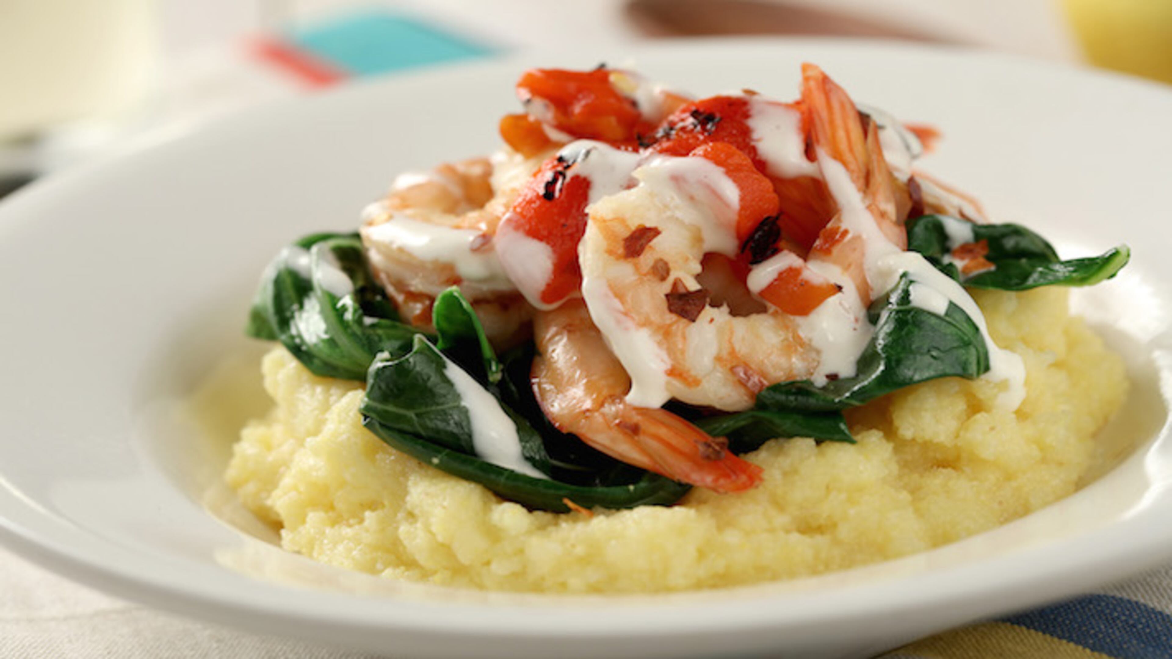 Grits with spicy collards, shrimp, roasted red peppers and aioli drizzle from Robin Asbell's "Great Bowls of Food." (Michael Tercha/Chicago Tribune/TNS)