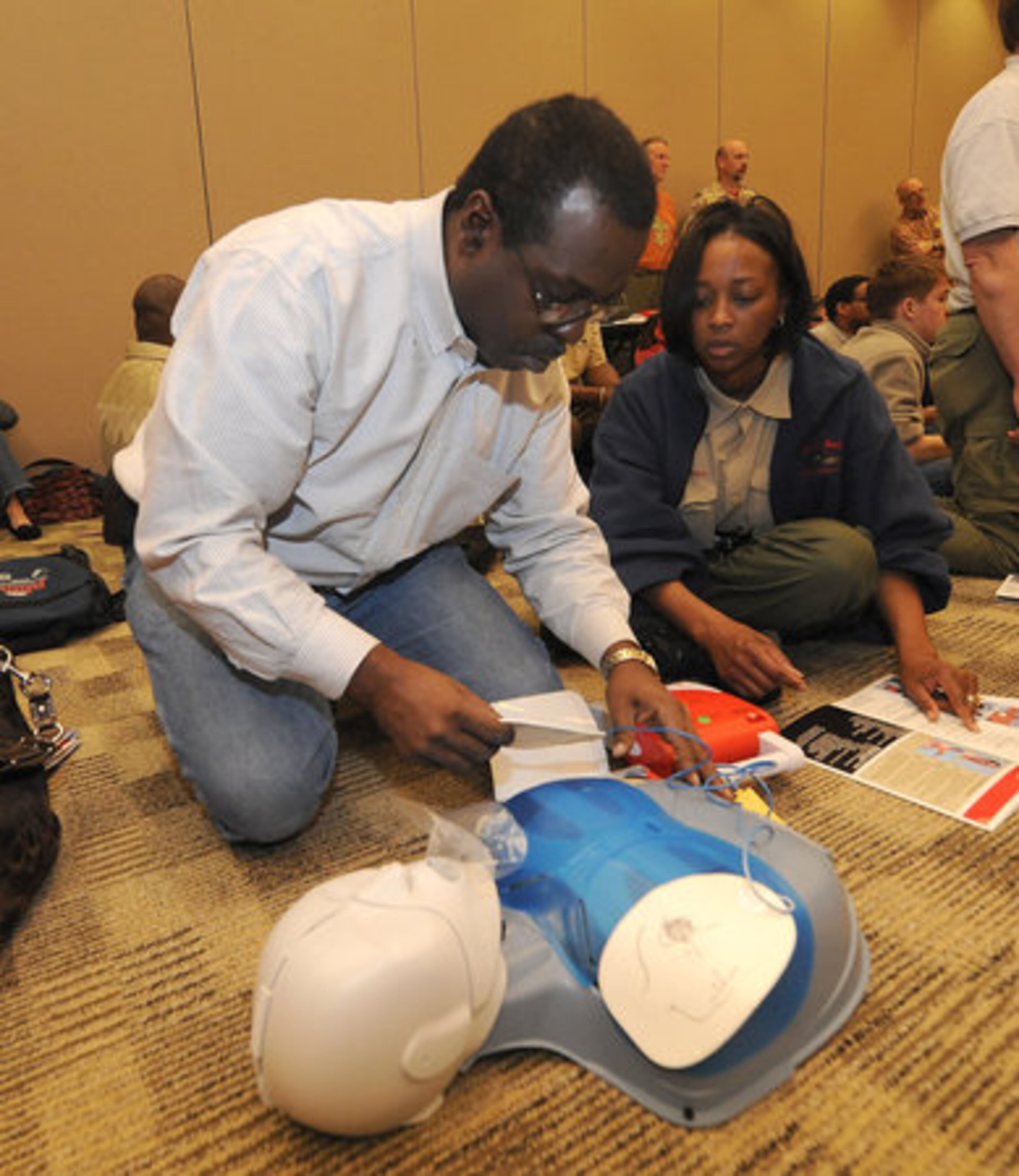 Ricky Johnson, and Corliss Austin - Harris, use an AED (Automated External Defibulator) on Scout CPR Saturday at the Boy Scouts of America's Atlanta Area Council Office on Saturday, March 6, 2010. The CPR classes were taught by the American Red Cross and certified Scout leaders.