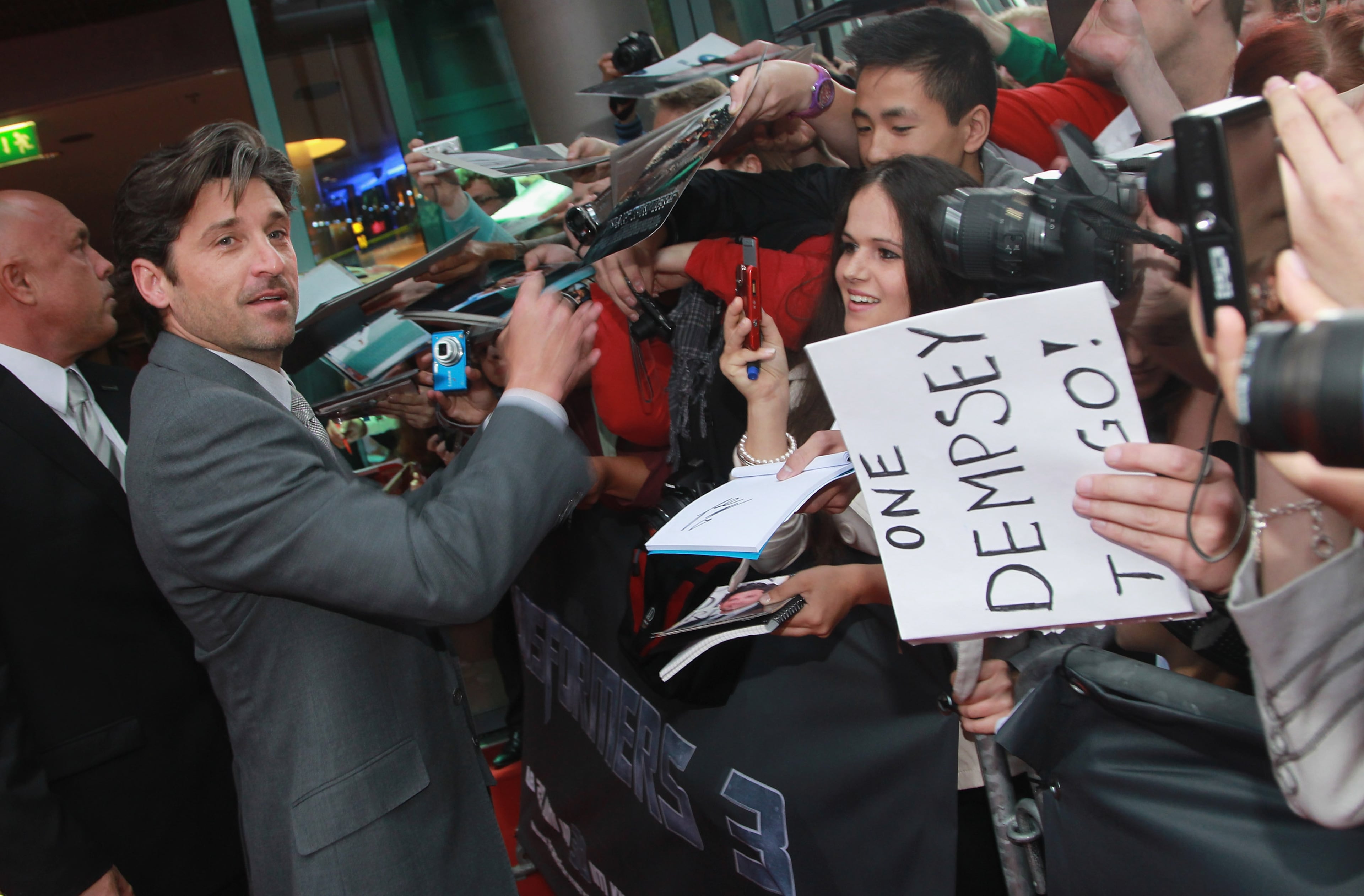 BERLIN, GERMANY - JUNE 25: Actor Patrick Dempsey signs autographs for fans as he attends the "Transformers 3" European premiere on June 25, 2011 in Berlin, Germany. (Photo by Sean Gallup/Getty Images for Paramount)