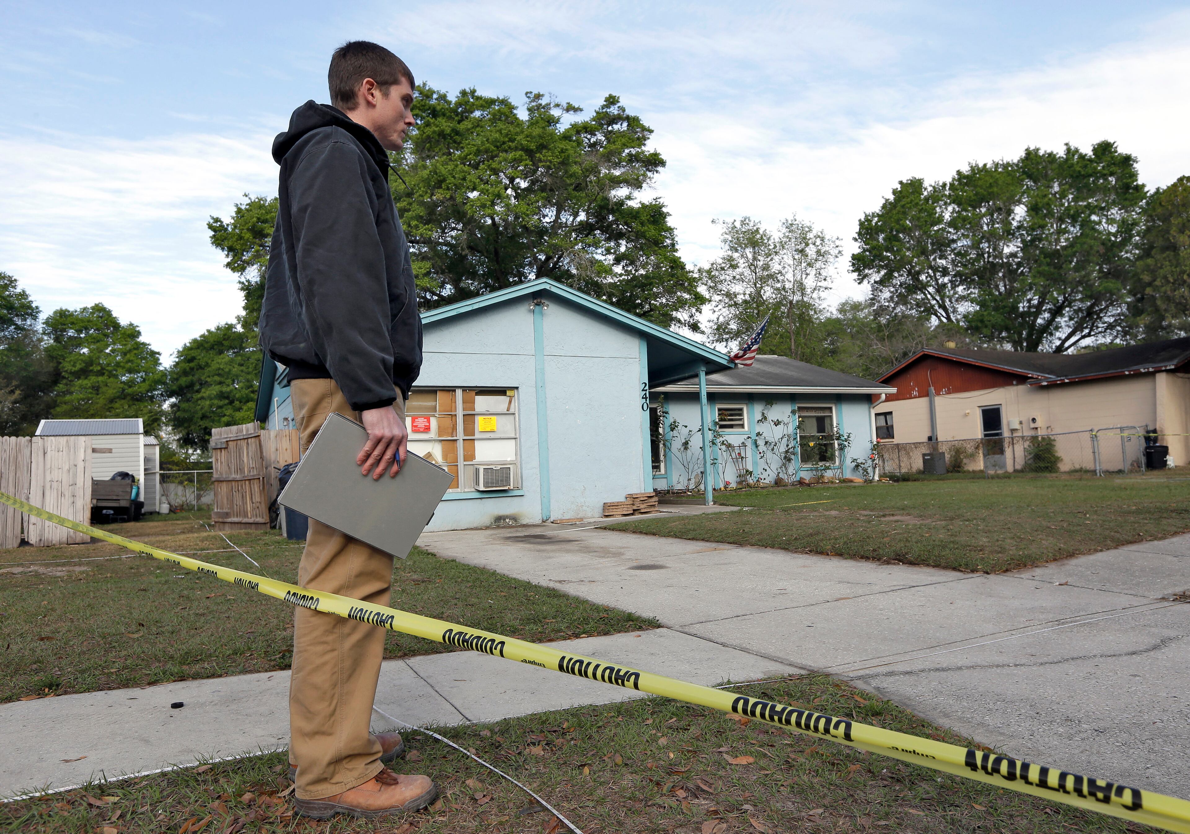 An engineer stands in front of the home.