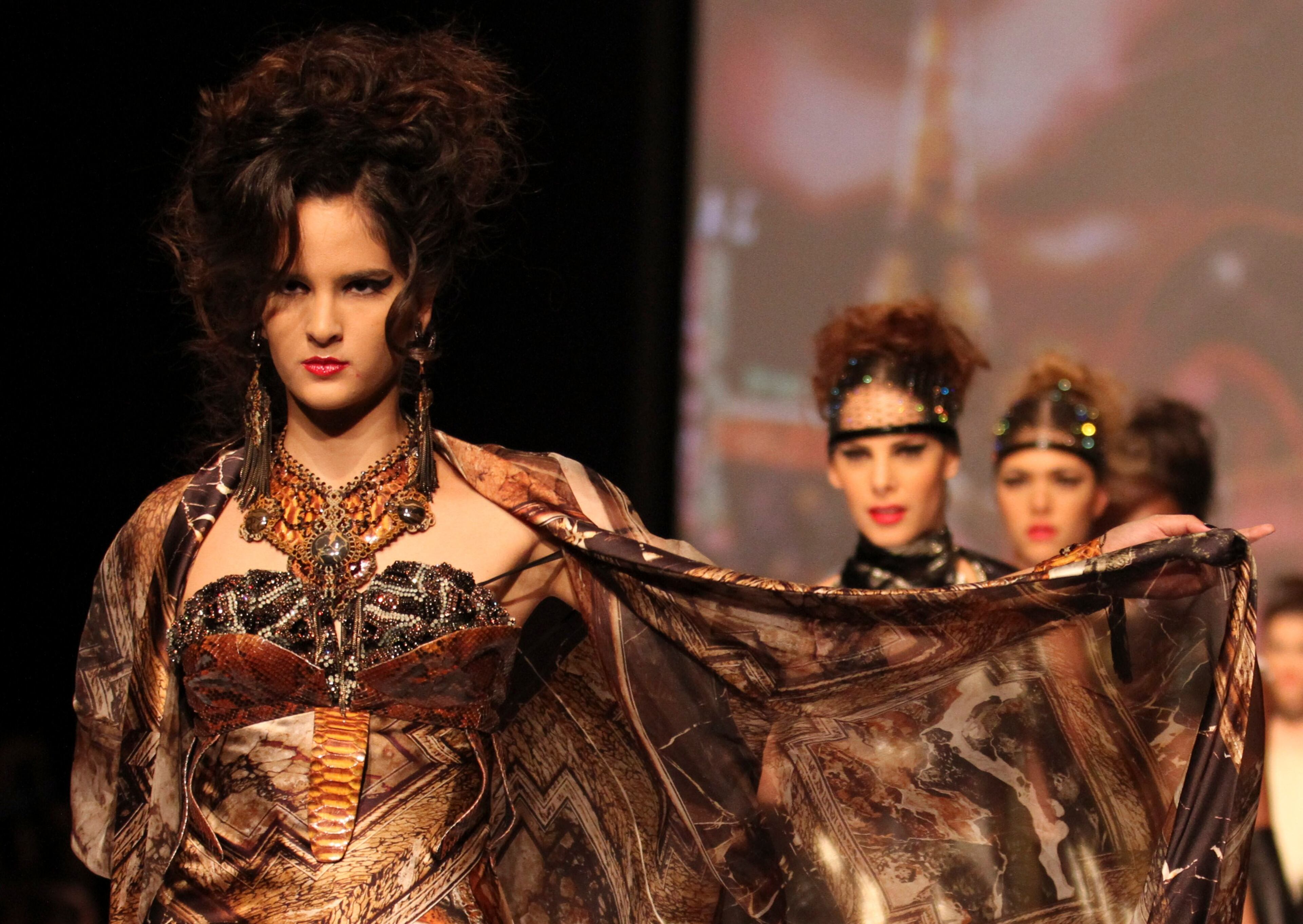 Models display creations by the French designer Jean Paul Gaultier during the Cali Exposhow fashion week in Cali, Colombia, Wednesday, Oct. 17, 2012.