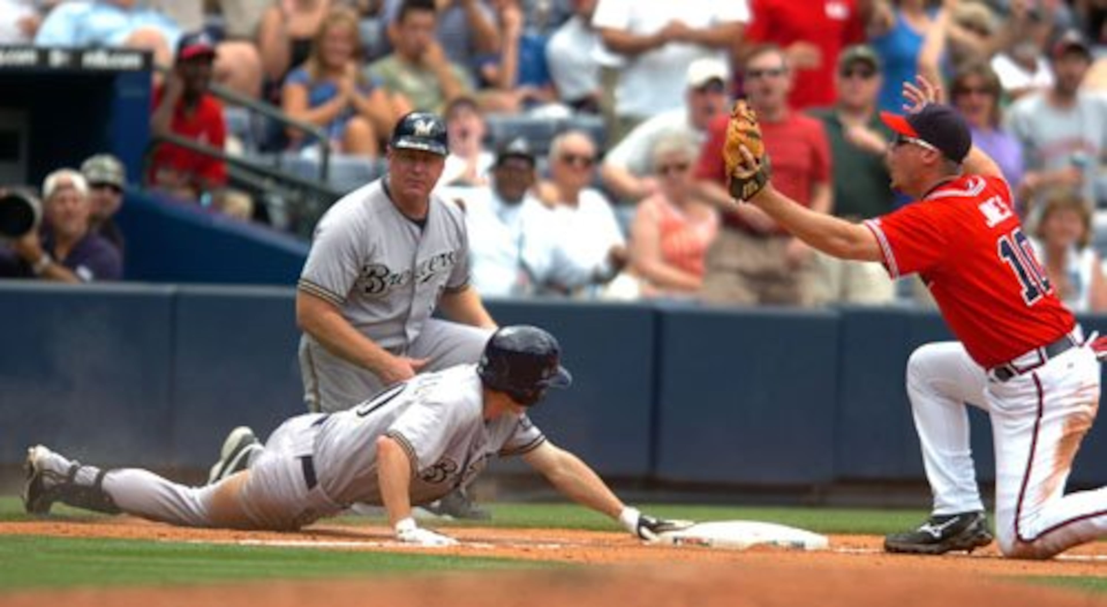Braves' third baseman Chipper Jones argues with the umpire after Craig Counsell was called safe for a triple in the seventh inning.