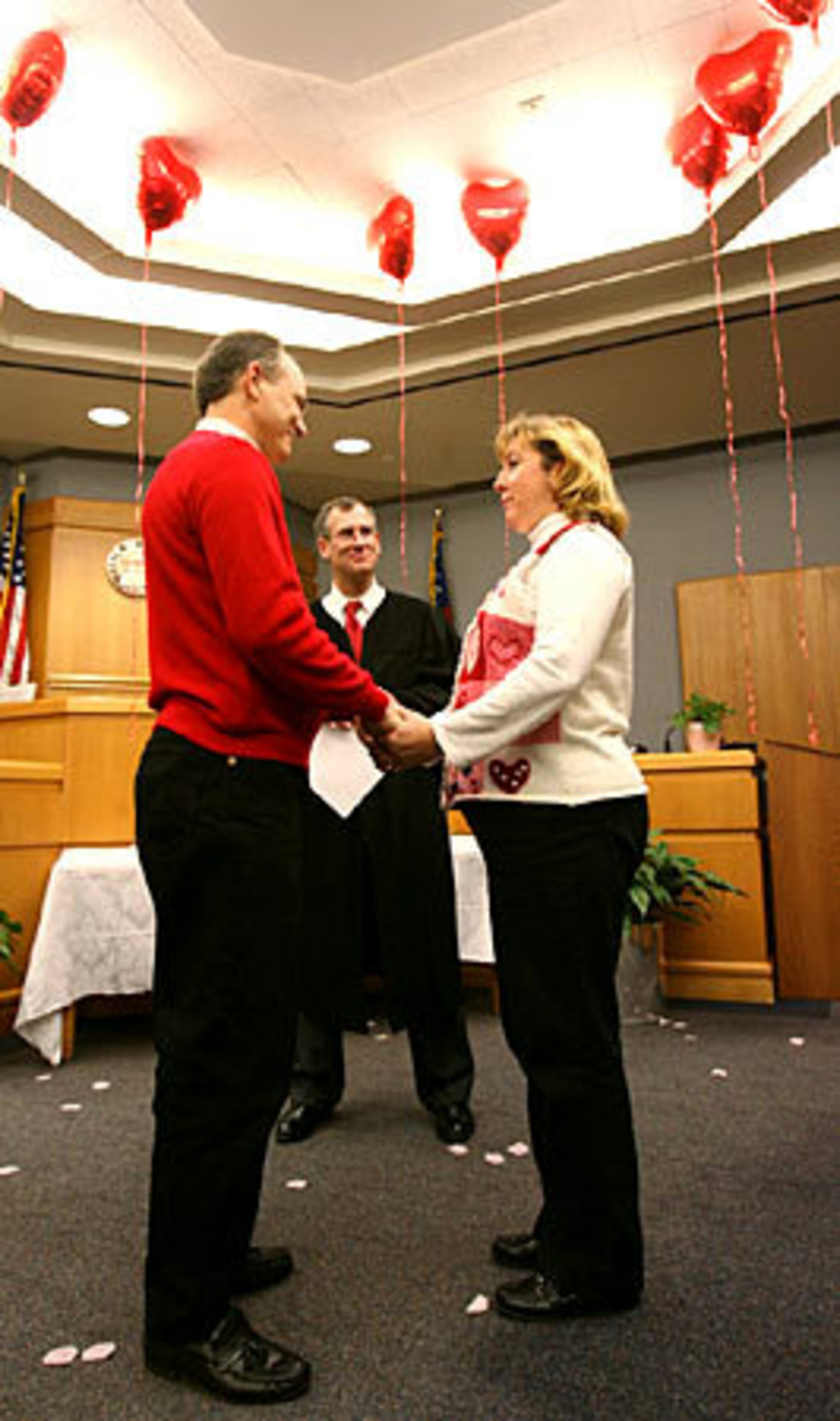 Valentine's Day in Gwinnett means one thing --wedding ceremonies. On that day, Gwinnett County Magistrate Court offers free marriages and marriage vow renewal ceremonies. Craig Myers (left) and his wife Angie Myers celebrate Valentine's Day as they renew their vows.