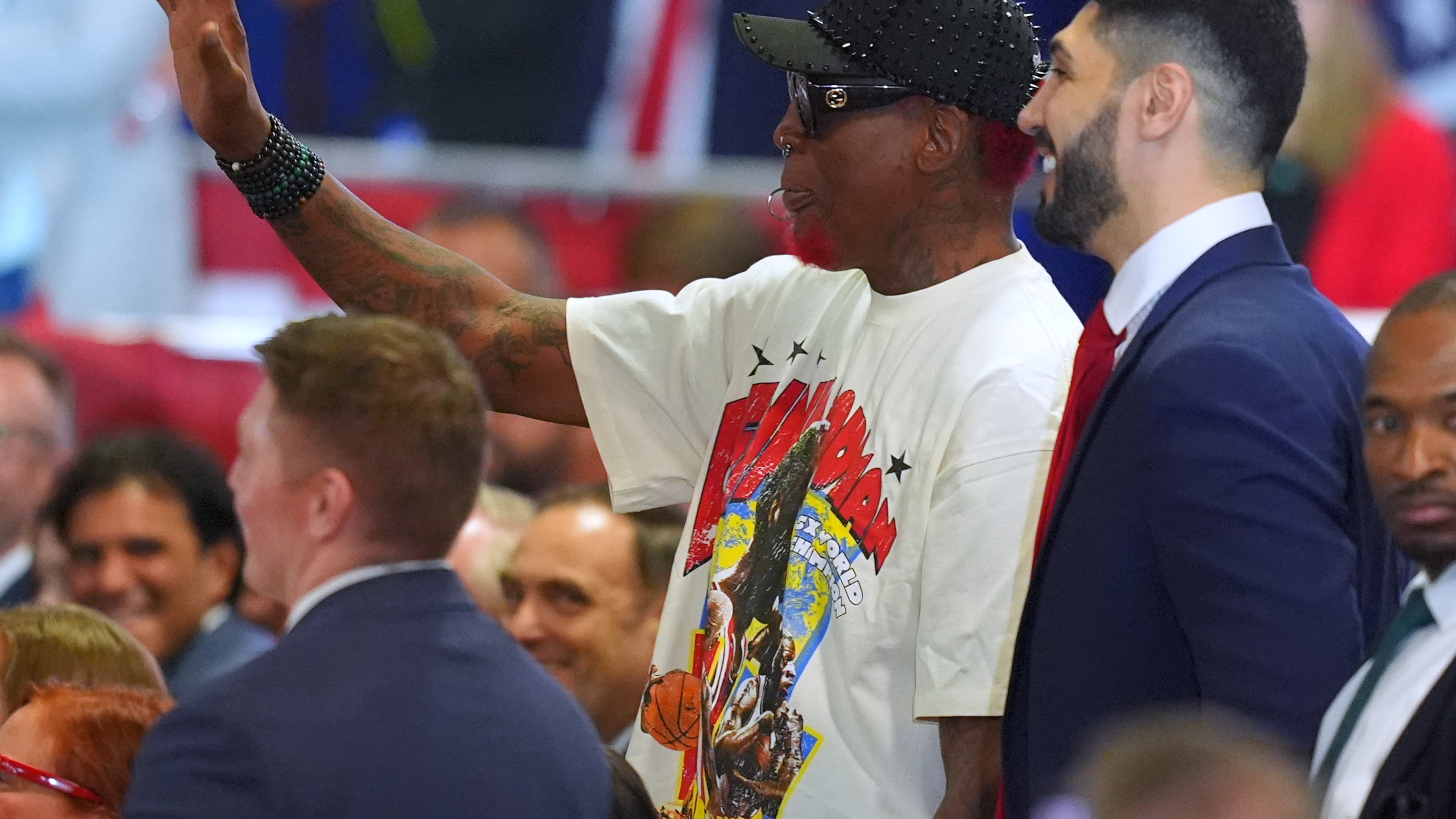 Dennis Rodman and Enes Freedom listen as President Donald Trump speaks at a campaign rally at the Choctaw Event Center, Thursday, Oct. 1, 2026, in Durant, Okla. (AP Photo/Julio Cortez)