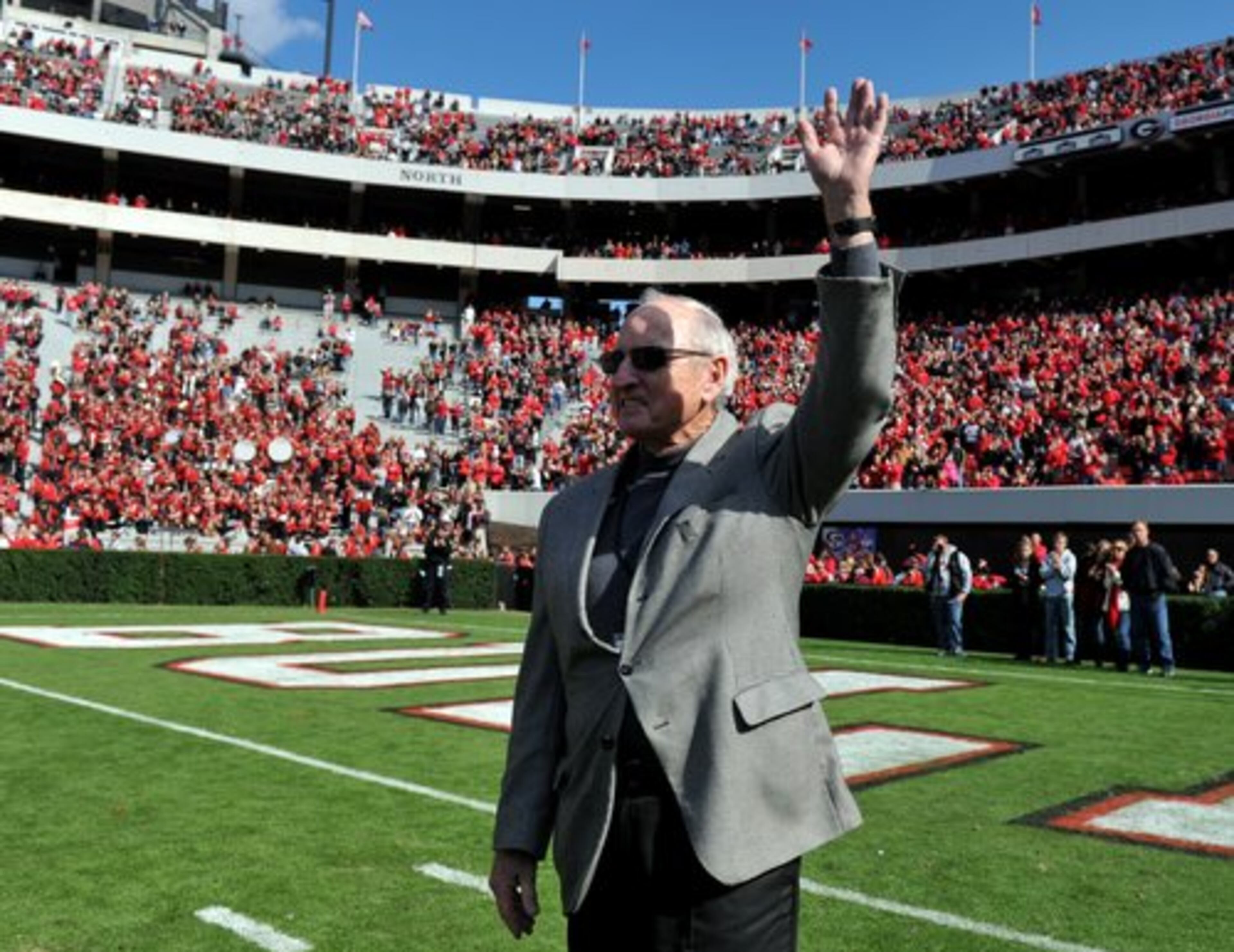 UGA legend Vince Dooley waves to the crowd as his 1980 national championship team was recognized at halftime.