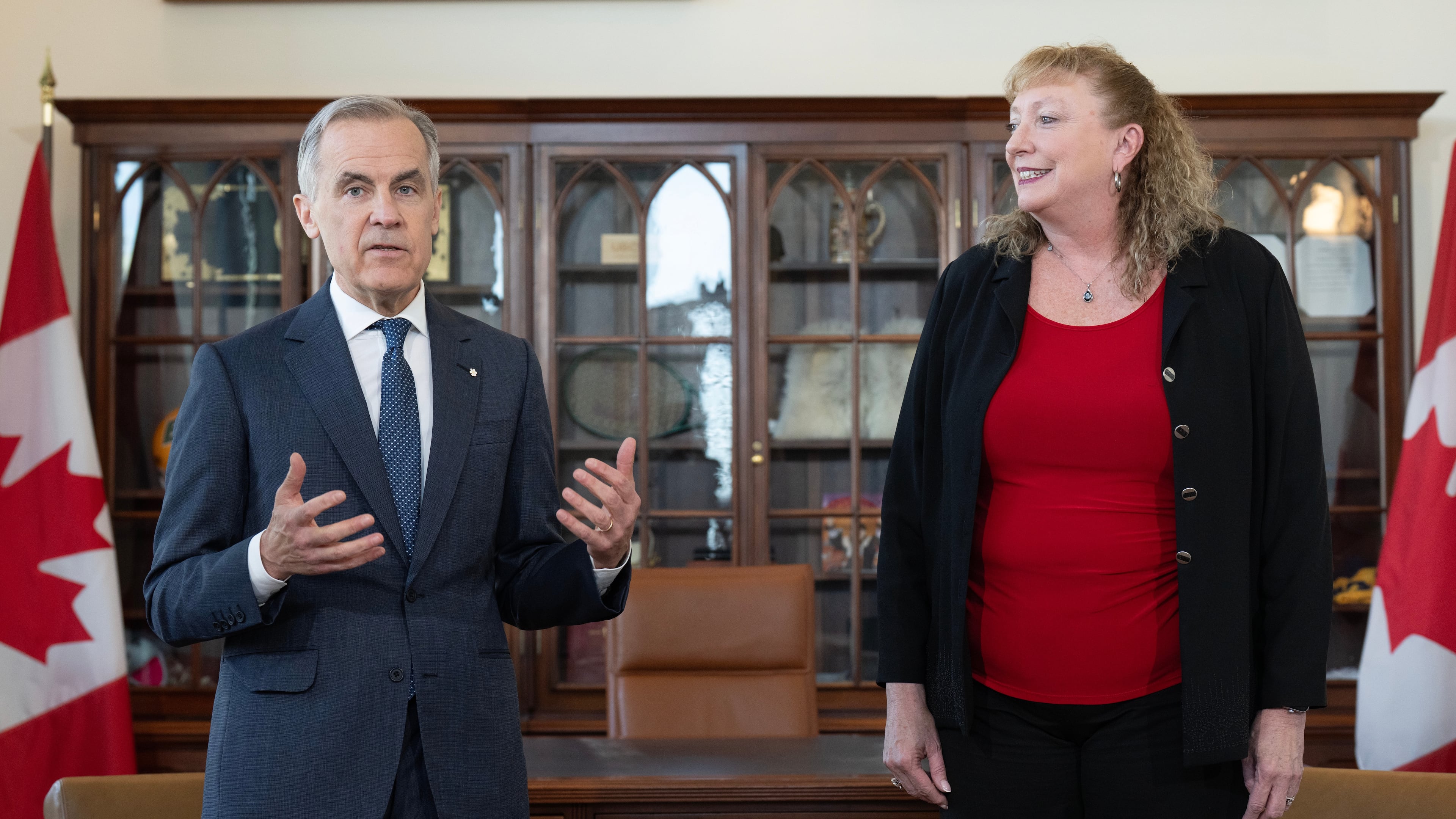 Prime Minister Mark Carney delivers some remarks as MP for Sarnia-Lambton-Bkejwanong Marilyn Gladu looks on during an event in his office in Ottawa, Wednesday, April 8, 2026. (Adrian Wyld /The Canadian Press via AP)