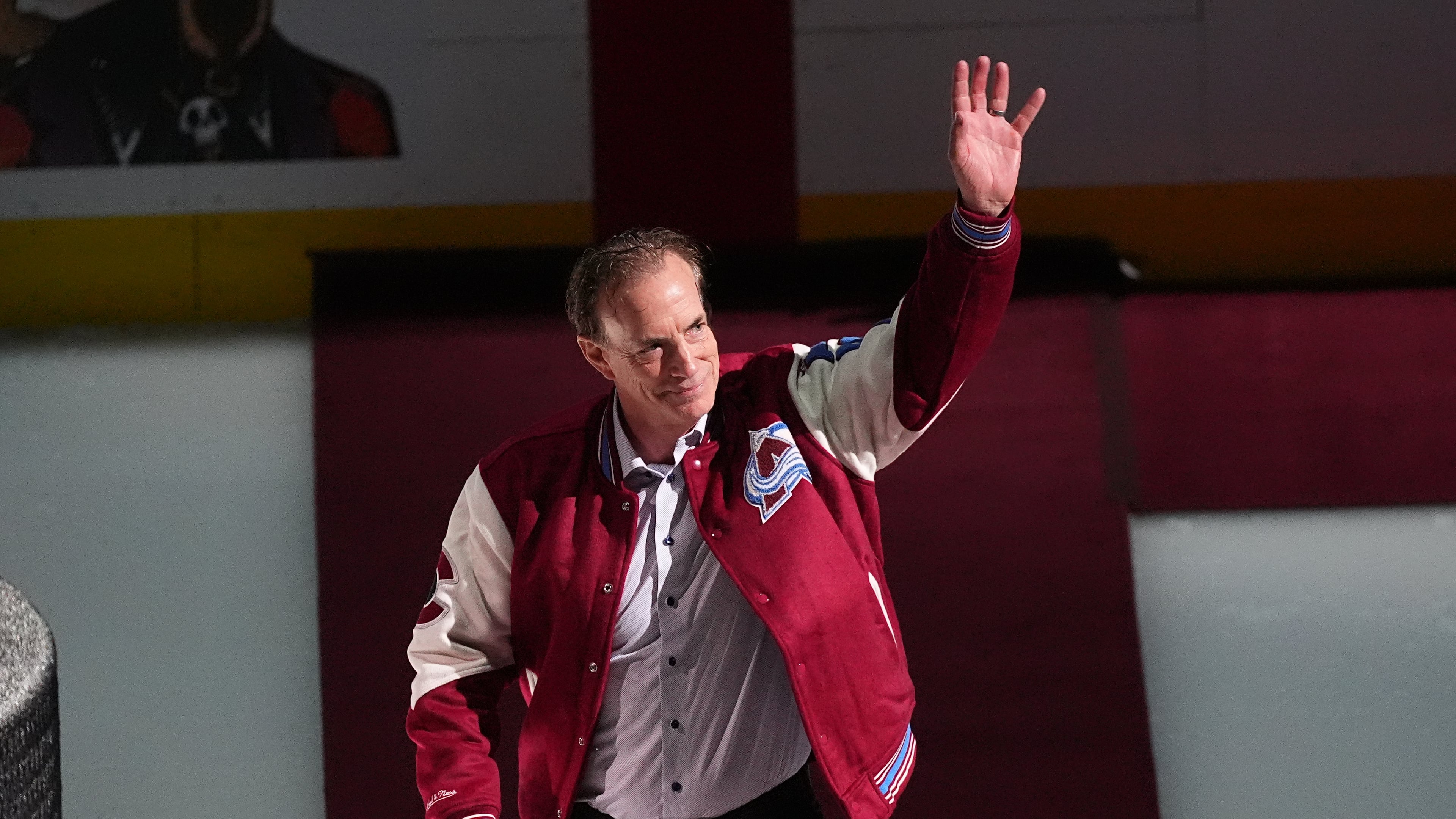 FILE - Joe Sakic, current general manager of the Colorado Avalanche as well as a member of the 1996 Stanley Cup Championship team, waves as he is introduced during a ceremony to mark the 30th anniversary of the win before an NHL hockey game against the Florida Panthers, on Dec. 11, 2025, in Denver. (AP Photo/David Zalubowski, File)