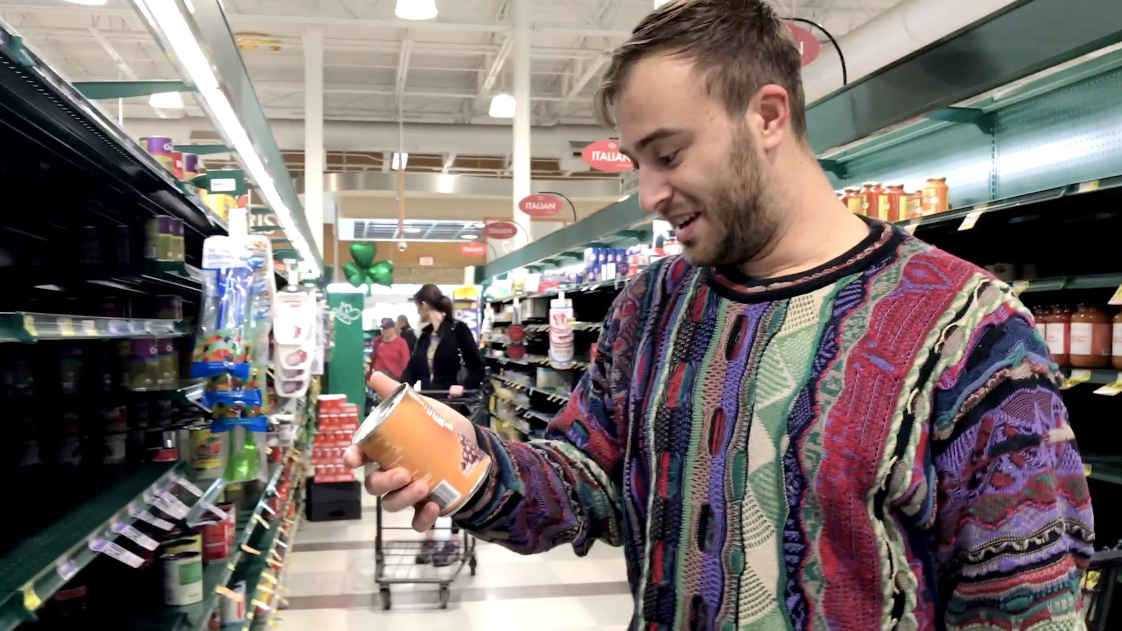 Griffin Brody grabs some canned food as he makes a grocery run for a person who requested it online in Charlotte, N.C. on March 14, 2020. Brody offered online to help the elderly or those who may be at risk during the coronavirus pandemic. Joshua Komer/Charlotte Observer/TNS