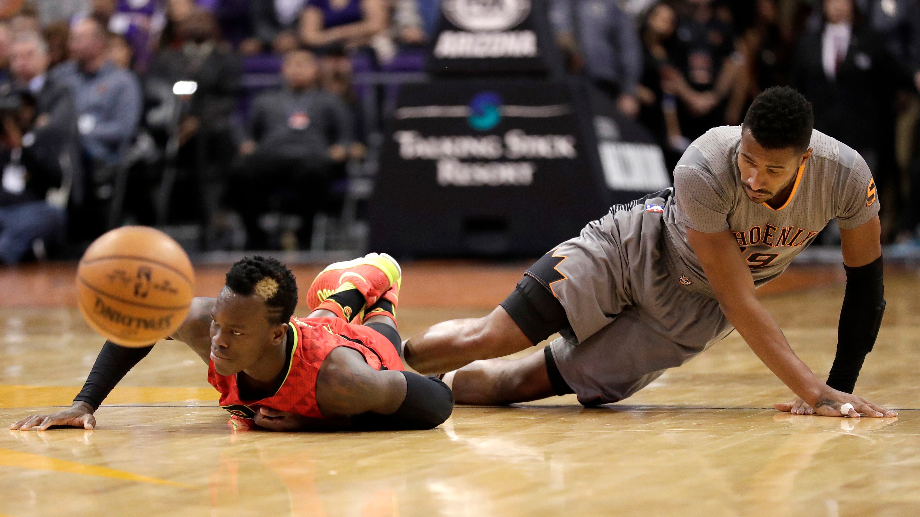 Phoenix Suns guard Leandro Barbosa, right, fouls Atlanta Hawks guard Dennis Schroder during the first half of an NBA basketball game, Wednesday, Nov. 30, 2016, in Phoenix. (AP Photo/Matt York)