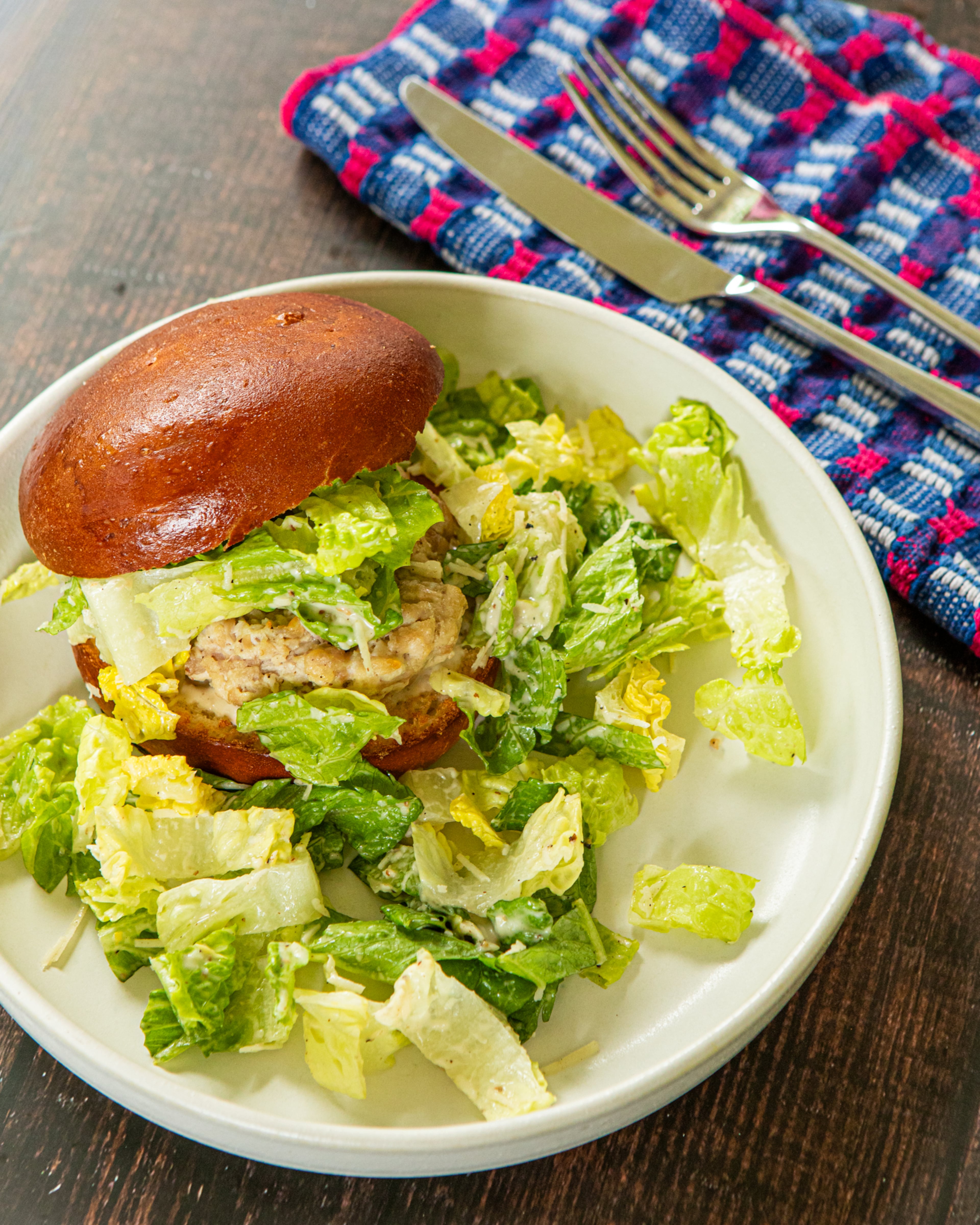Chicken Caesar Burger made and styled by writer Kate Itrich-Williams at her home in Atlanta on Thursday, July 23, 2026, for the 5:30 challenge. (Aaliyah Man for the AJC)
