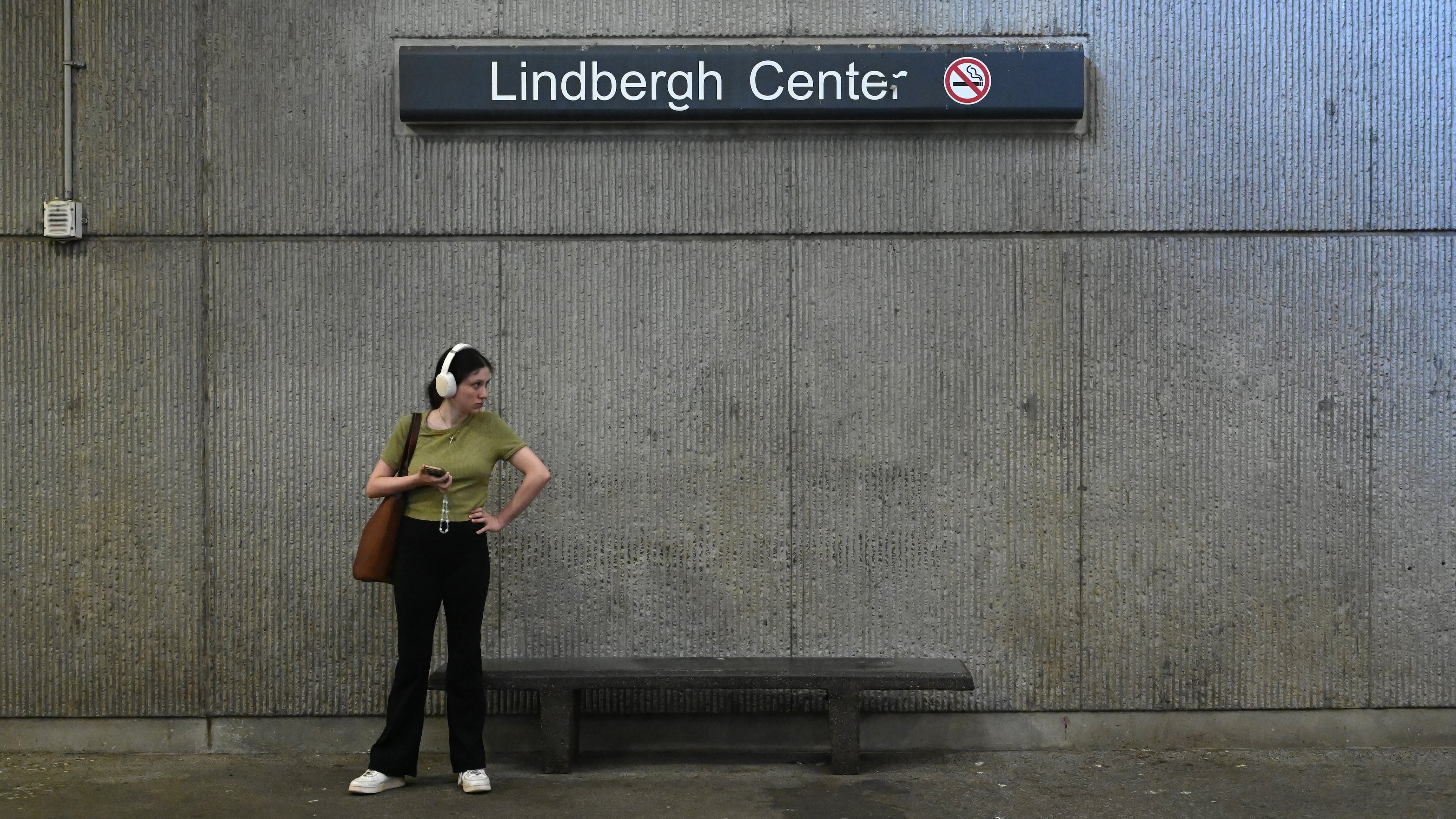 A MARTA rider waits at the Lindbergh Center station for a Gold Line/Red Line train in September 2025. MARTA has recommended Lindbergh Center as the Clifton Corridor endpoint, rather than Armour Yards. (Hyosub Shin/AJC 2025)