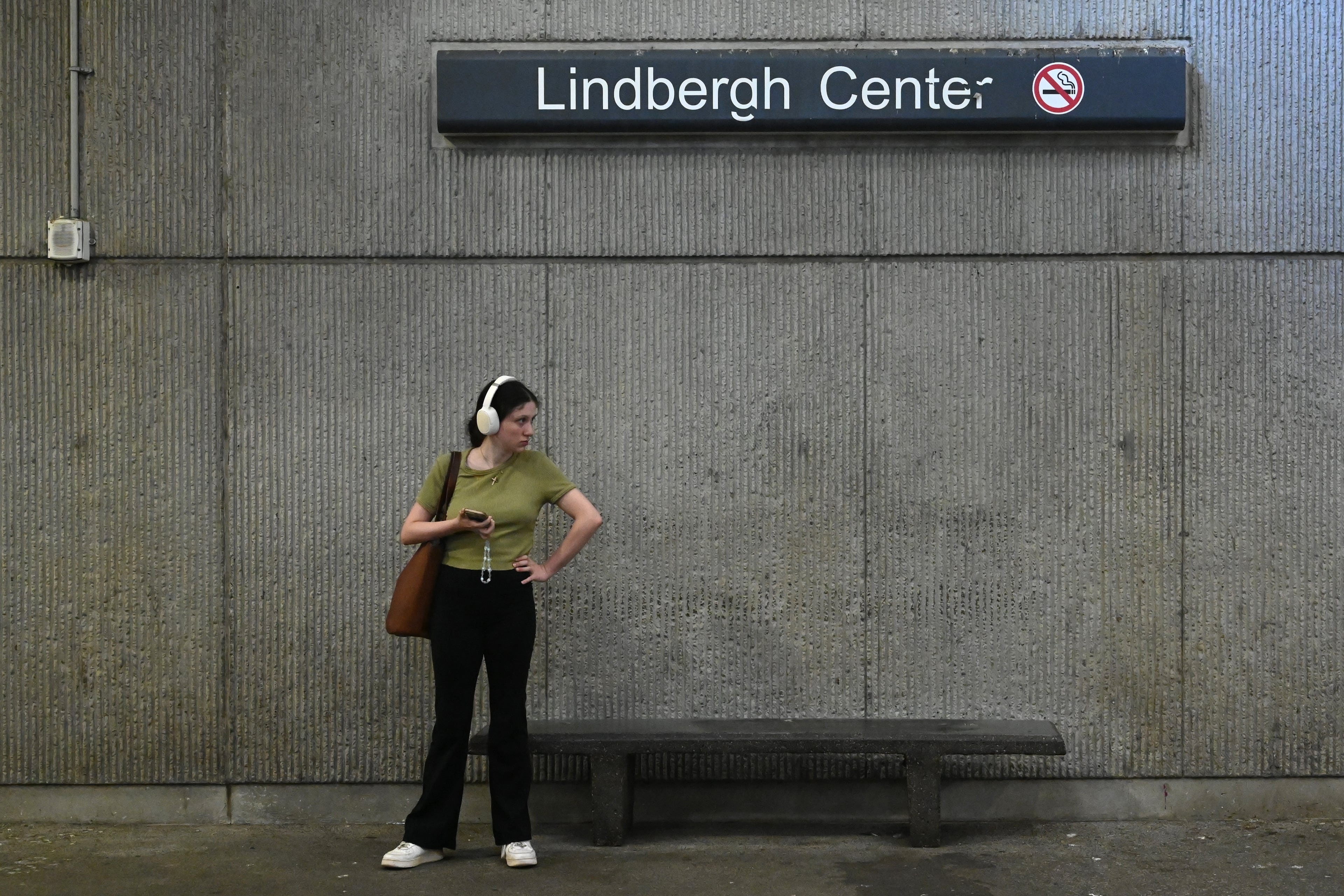 A MARTA rider waits at the Lindbergh Center station for a Gold Line/Red Line train in September 2025. MARTA has recommended Lindbergh Center as the Clifton Corridor endpoint, rather than Armour Yards. (Hyosub Shin/AJC 2025)