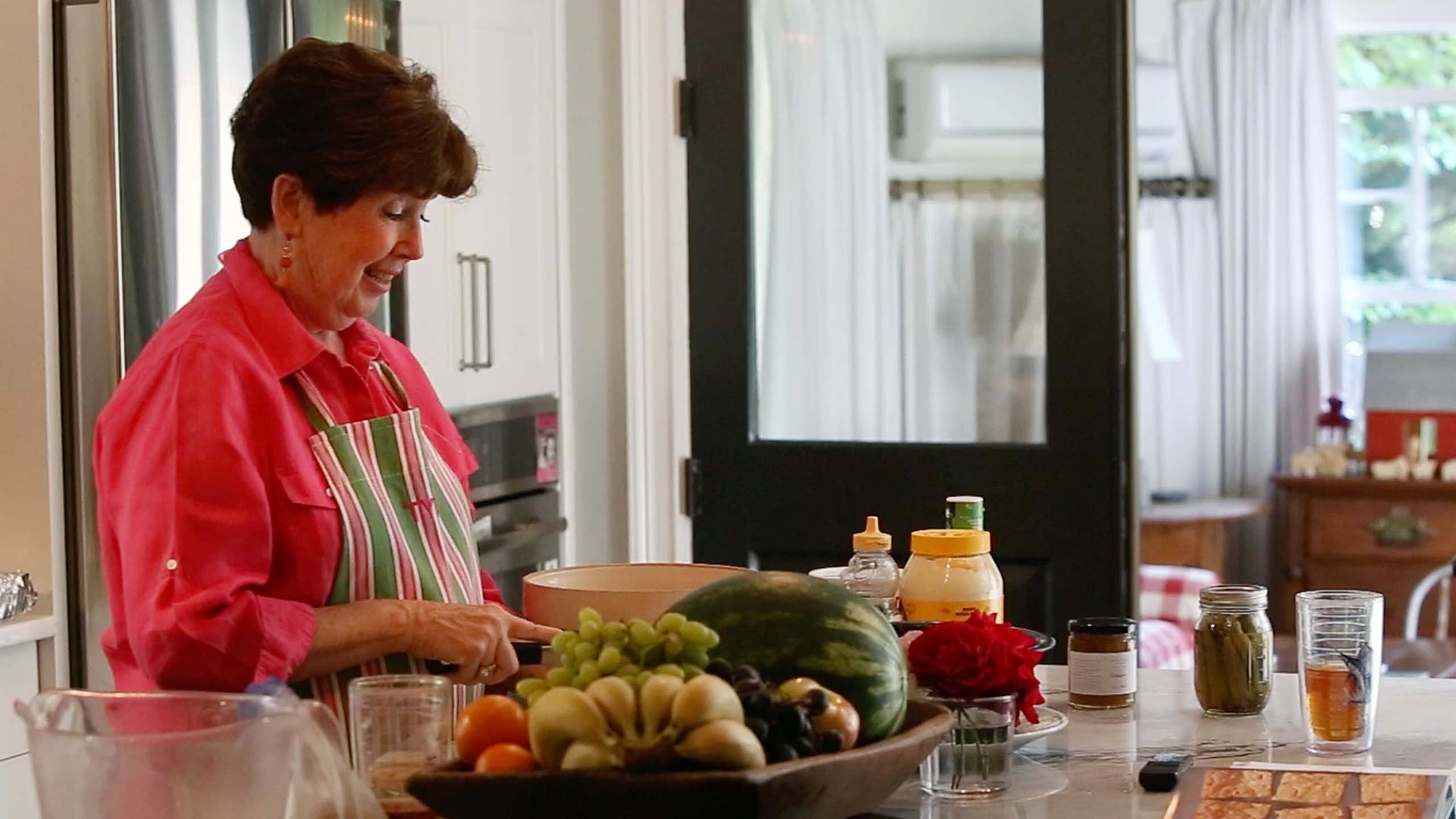 Mary Kay Andrews (aka Kathy Hogan Trocheck) cooking a dish from her cookbook in her Avondale Estates home.