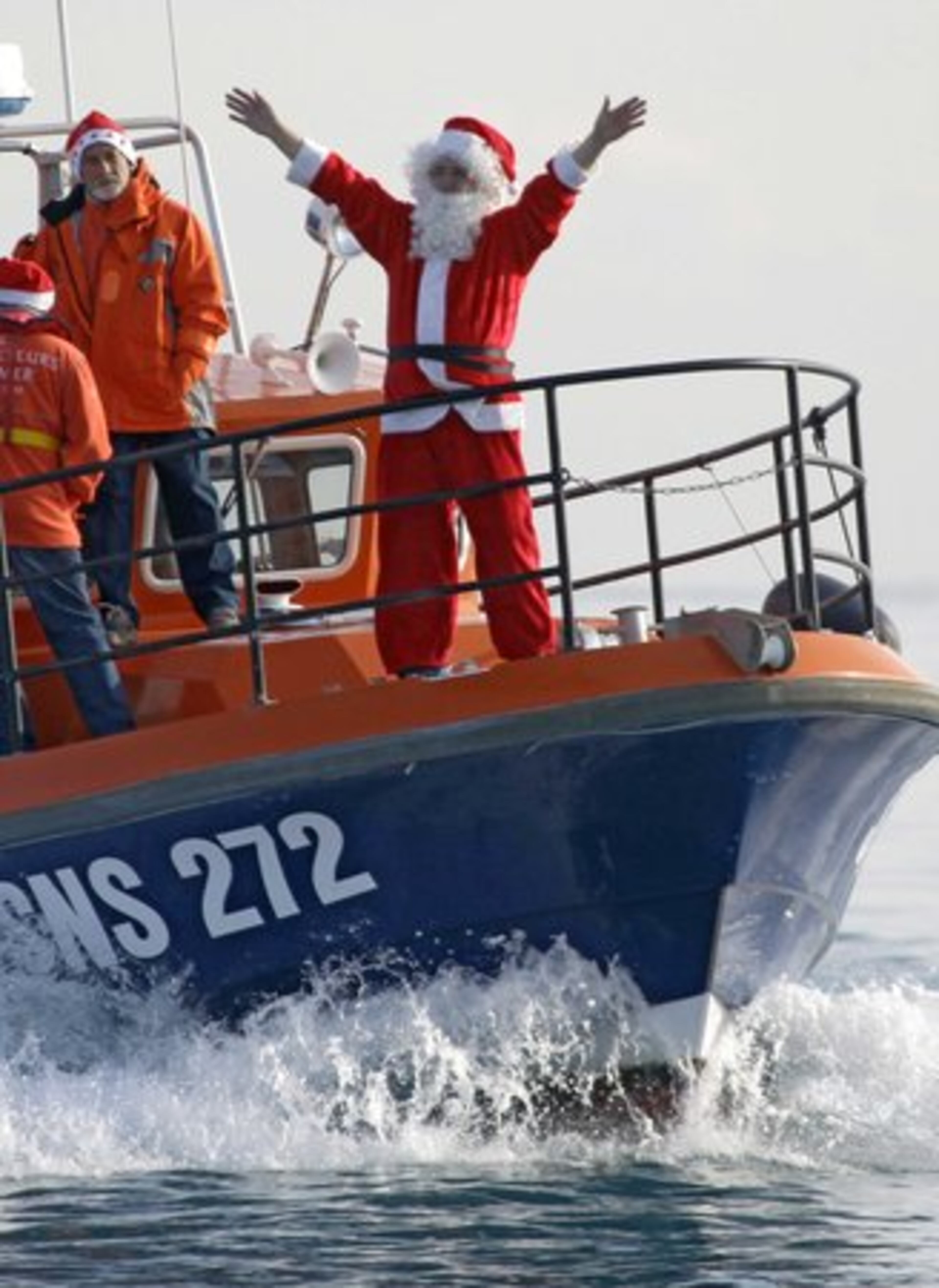 Santa rejoices as he participates in holiday festivities at sea in France.
