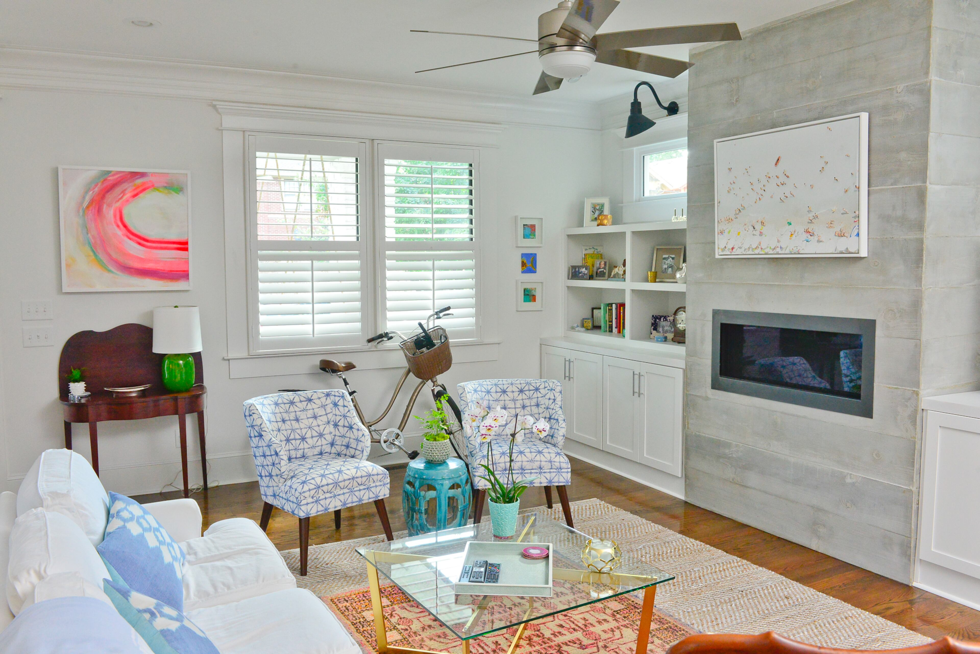 White layered rugs beneath the coffee table in her Old Fourth Ward living room to incorporate more style and color. The larger rug on the bottom is from Serena and Lily, and the smaller, brighter one came from Kishi's Rugs and Antiques.
