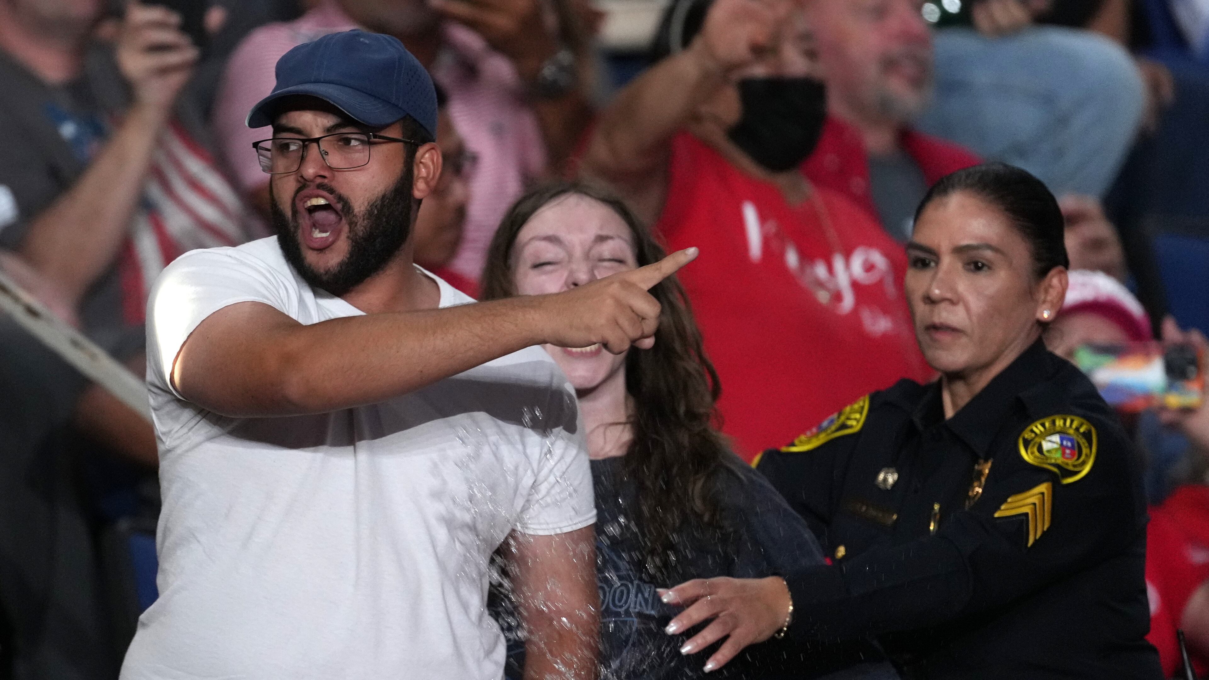 Police remove protesters as President Donald Trump speaks at a campaign rally at the Freeman Coliseum in San Antonio, Wednesday, Oct. 7, 2026. (AP Photo/Eric Gay)