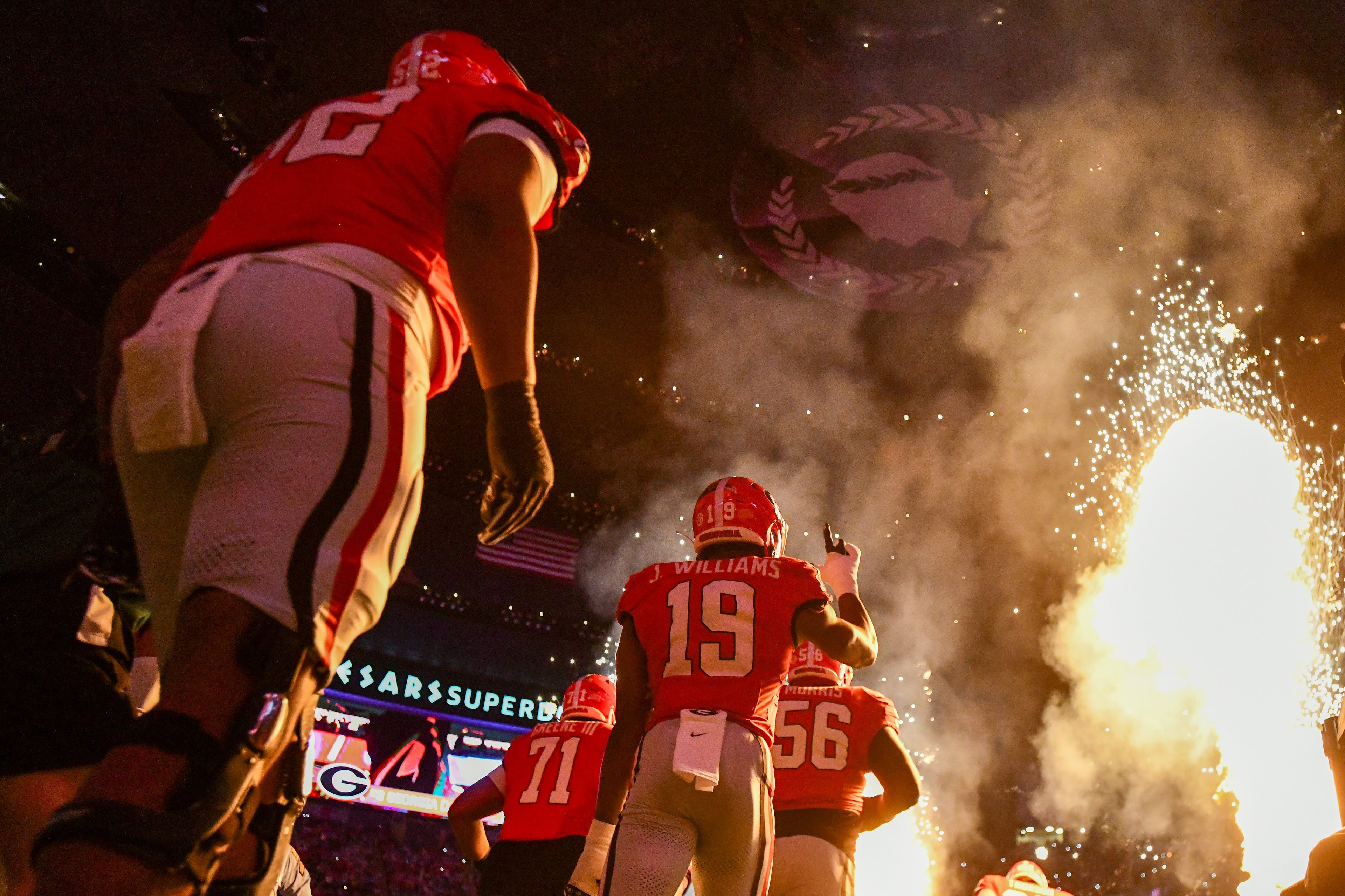 The Georgia Bulldogs team enters the field amid pyrotechnics for the Ole Miss NCAA College Football Playoff quarterfinal game at the Sugar Bowl in the Caesars Superdome, Thursday, Jan. 1, 2026, in New Orleans. (Hyosub Shin/AJC)
